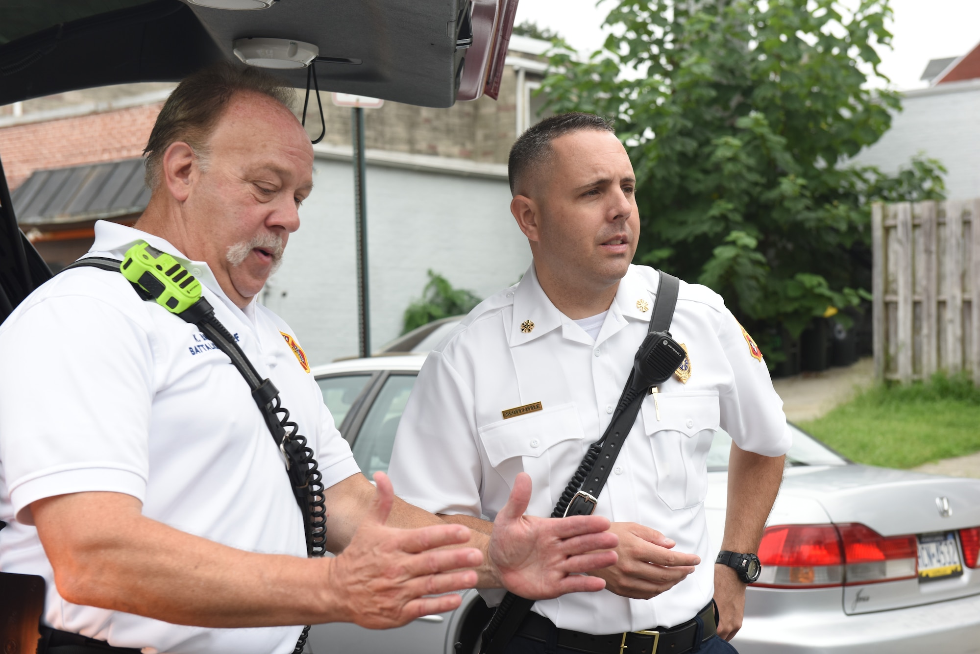 Scott Little, right, fire chief of Lancaster’s Bureau of Fire, gets briefed on the scene of a gas leak by the on-scene battalion chief Aug. 21, 2018, Lancaster, Pennsylvania. A pipe was struck during road work that created a gas leak, which resulted the road being closed off for hours until it was under control. (U.S. Air National Guard photo by Senior Airman Julia Sorber/Released)