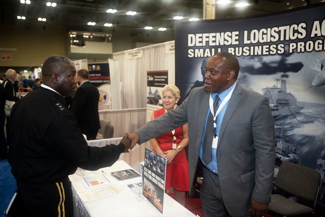 Defense Logistics Agency Director Army Lt. Gen. Darrell K. Williams greets members of the DLA Land and Maritime Small Business Office Earl Madison and Ami Banks during a visit to the exhibition hall June 19 shortly after his keynote address to kick off the 2018 DLA Land and Maritime Supplier Conference and Exposition in downtown Columbus, Ohio.