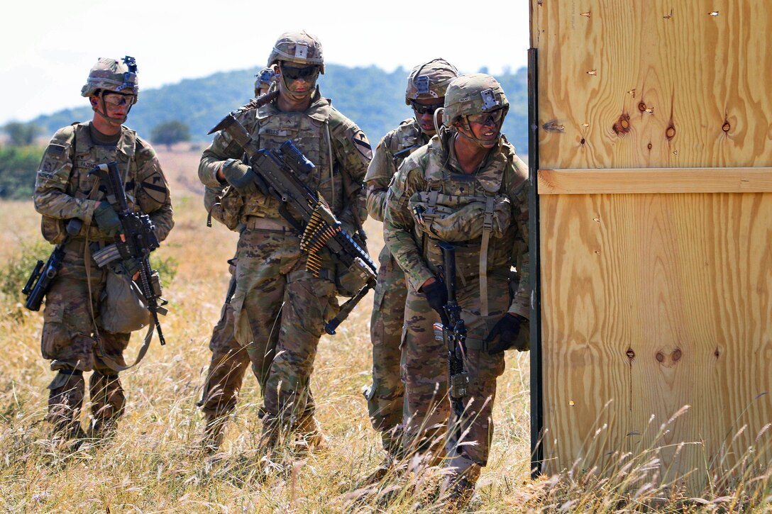 Soldiers prepare to move out and maneuver toward their follow-on objective.
