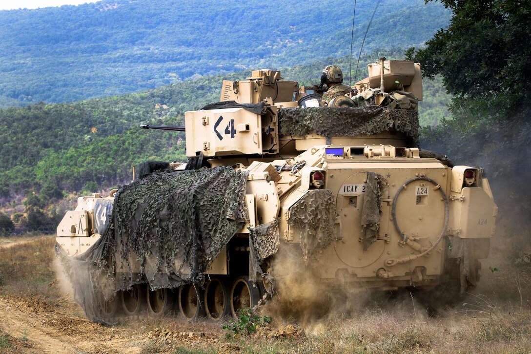 Soldiers maneuver their M2A3 Bradley fighting vehicle during a live-fire exercise.