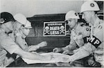 Georgia Army National Guard Lt. Col. John P. Wallis identifies a roadblock position on a map for Georgia Guard Soldiers of the Elberton-based 950th Antiaircraft Artillery Battalion.