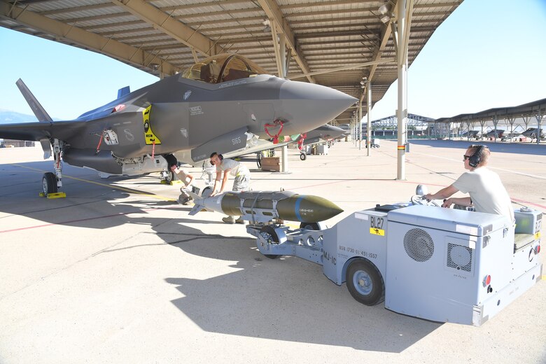 (Left to right) Staff Sgt. Nathan West, Airman 1st Class Benjamin Albert and Senior Airman Kasey Clark, 388th Aircraft Maintenance Squadron, load target munitions on an F-35A Lightning II Aug. 8, 2018, a Hill Air Force Base, Utah. Airmen and F-35s from the active-duty 388th Fighter Wing and Reserve 419th Fighter Wing at Hill AFB participated in the Air Force’s Weapon System Evaluation Program known as Combat Hammer. (U.S. Air Force photo by Todd Cromar)