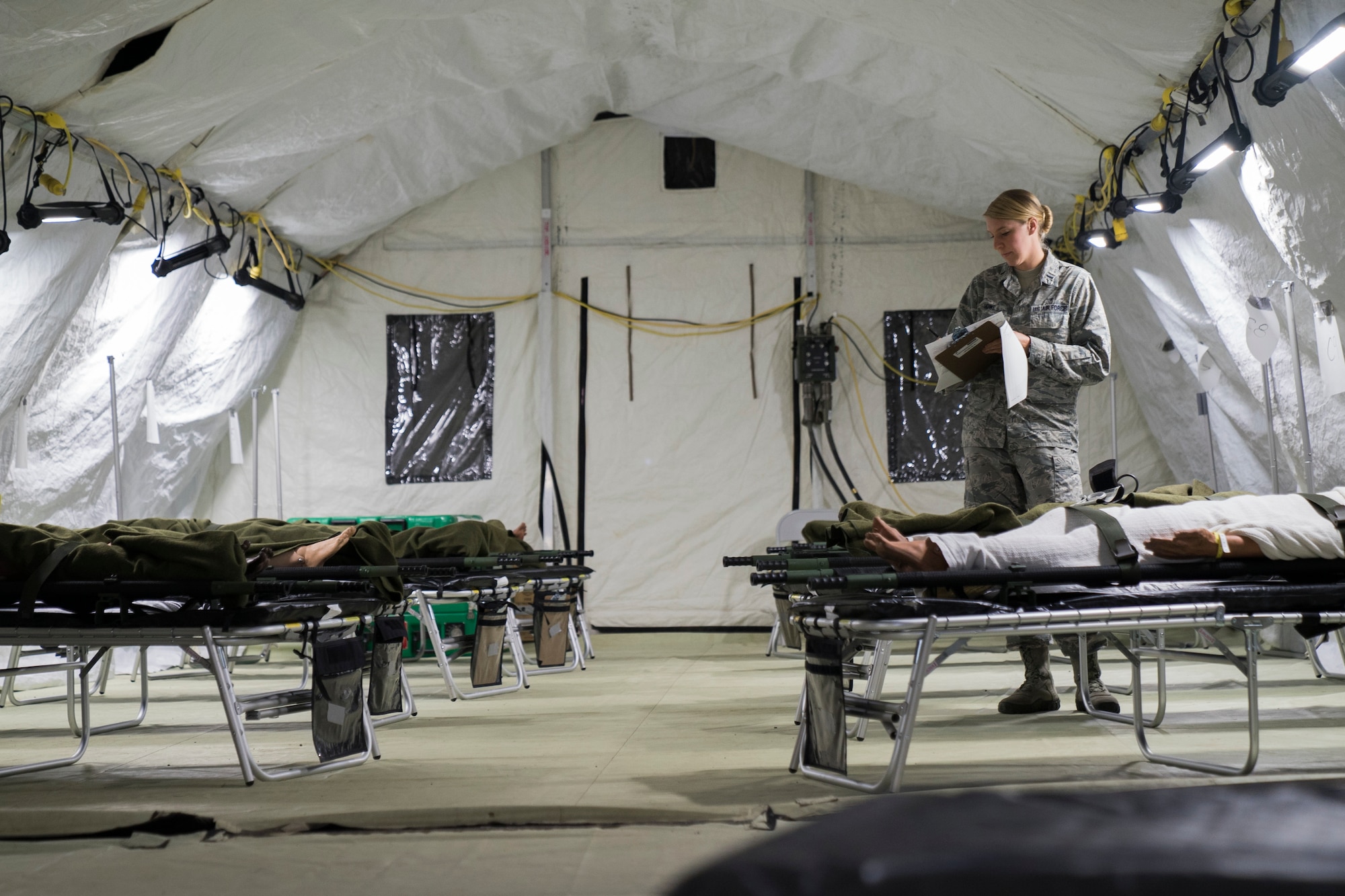U.S. Air Force Reserve 1st Lt. Rebekah Howe, 60th Medical Group clinical nurse, reviews patient information inside an Air Force Expeditionary Medical Support System tent during Exercise Ultimate Caduceus 2018 at Travis Air Force Base, California, Aug. 22, 2018. Ultimate Caduceus 2018 is an annual patient movement exercise designed to test the ability of U.S. Transportation Command to provide medical evacuation. (U.S. Air Force photo by Jamal D. Sutter)