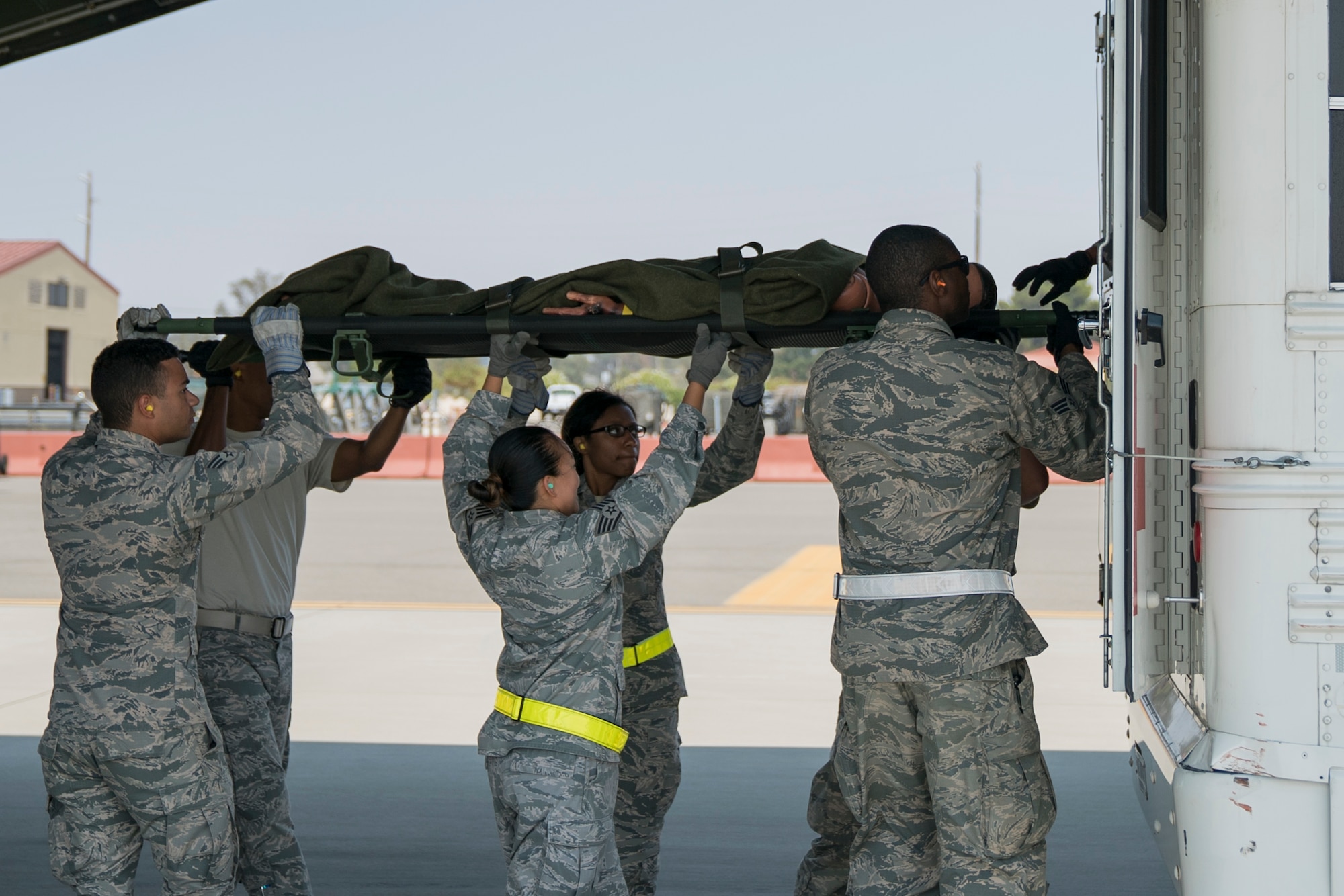 U.S. Air Force medical personnel load simulated patients onto an ambulance bus during Exercise Ultimate Caduceus 2018 at Travis Air Force Base, California, Aug. 22, 2018. Ultimate Caduceus 2018 is an annual patient movement exercise designed to test the ability of U.S. Transportation Command to provide medical evacuation. (U.S. Air Force photo by Jamal D. Sutter)