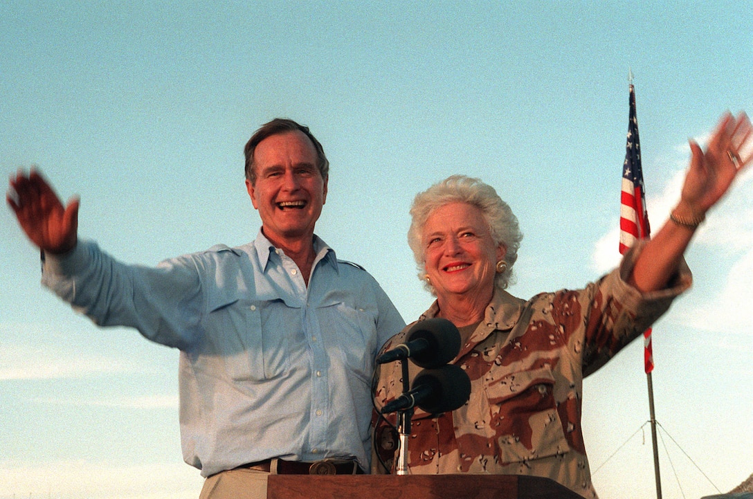 President George H.W. Bush and First Lady Barbara Bush wave and smile.