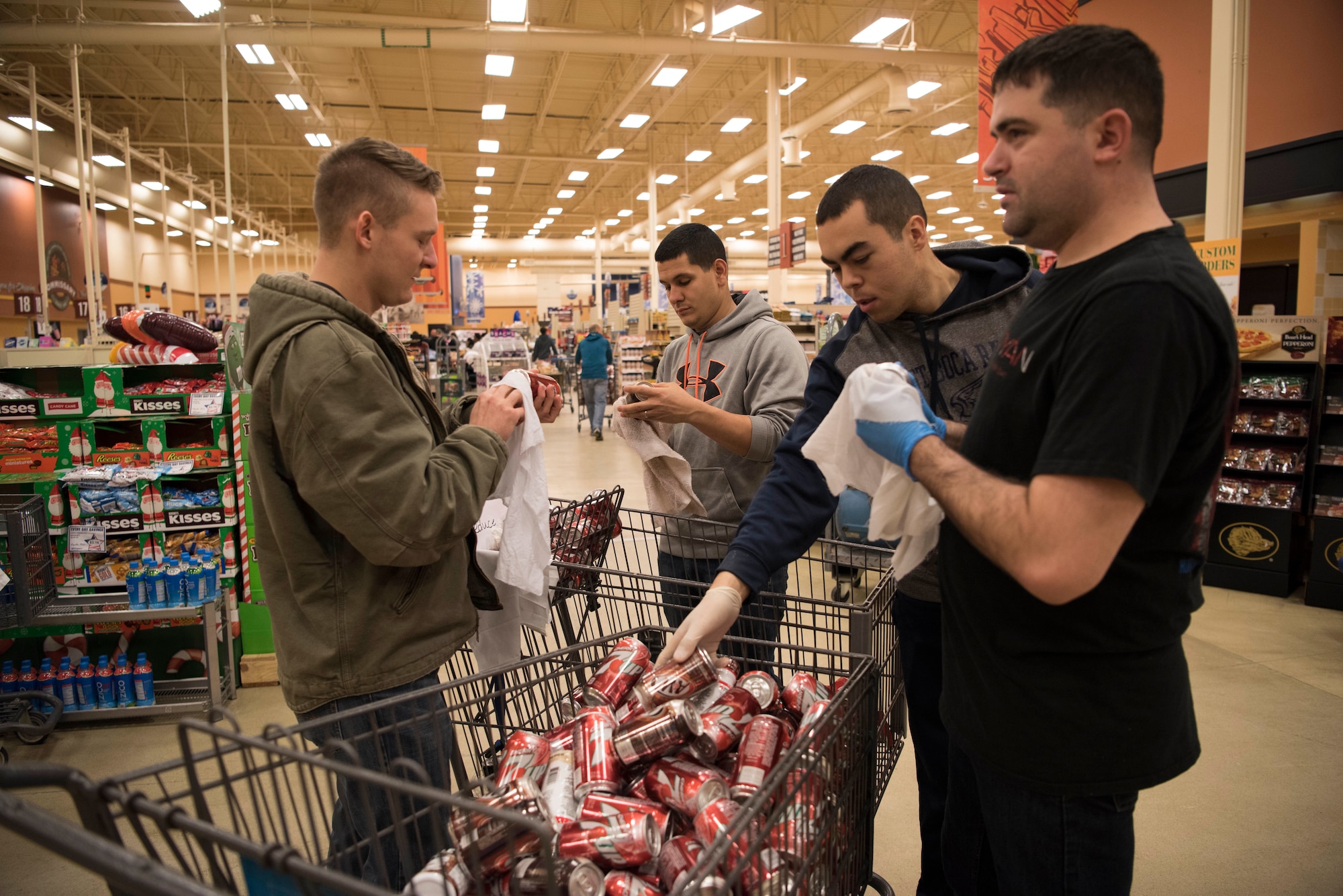 Active duty service members volunteer their time to clean up the Joint Base Elmendorf-Richardson, Alaska, Commissary Dec. 1, 2018. In less than 48 hours after the 7.0 magnitude Earthquake striking the Anchorage area at 8:29 a.m. the morning of Nov.30, 2018, JBER is mission ready and capable of resuming regular operations.