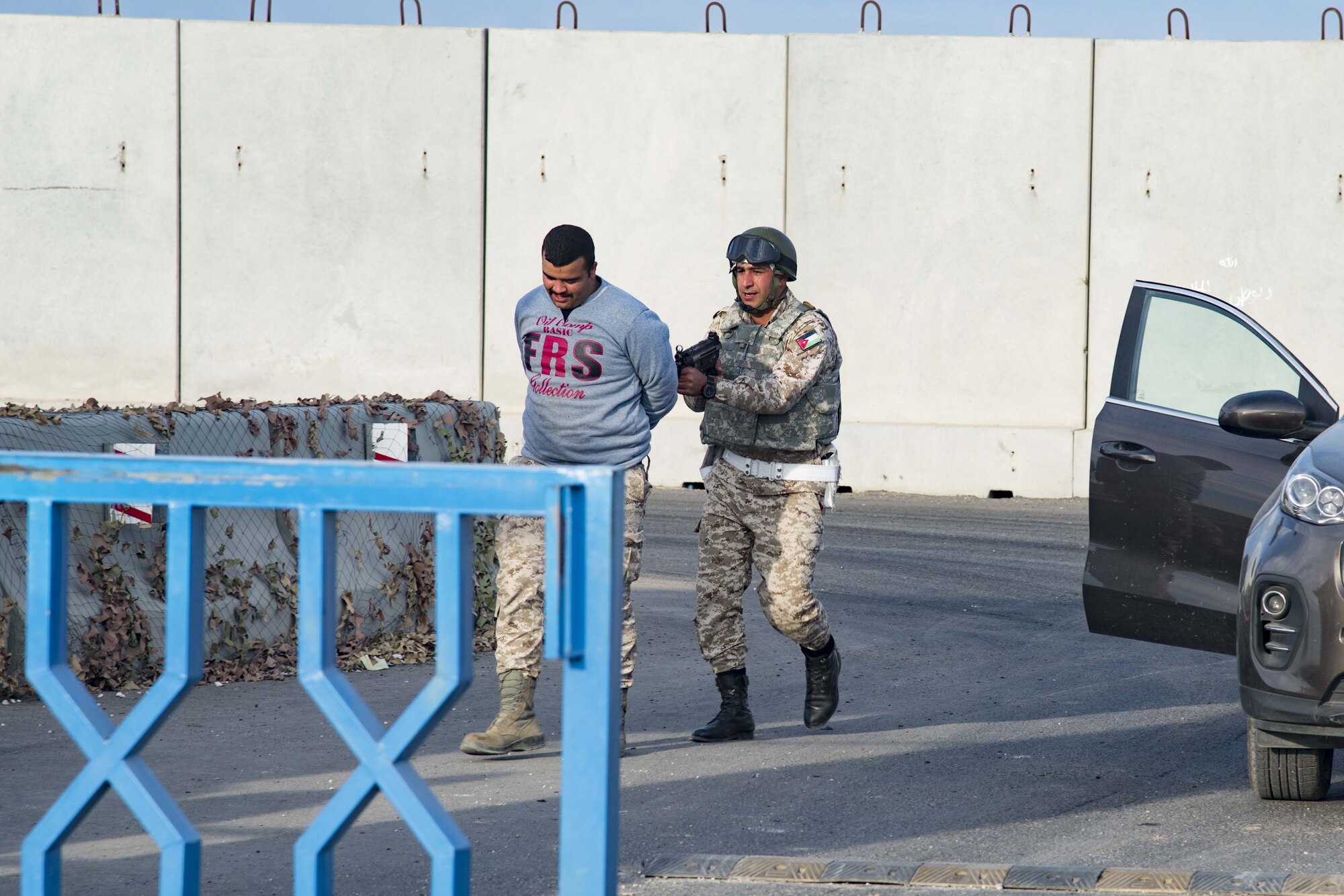 A Royal Jordanian Air Force force protection professional apprehends a simulated intruder at a base outside of Amman, Jordan Nov. 27.  The simulation was part of a joint partnership training exercise with U.S. Forces visiting there.  (U.S. Air Force photo by Staff Sgt. Stephen Eigel)