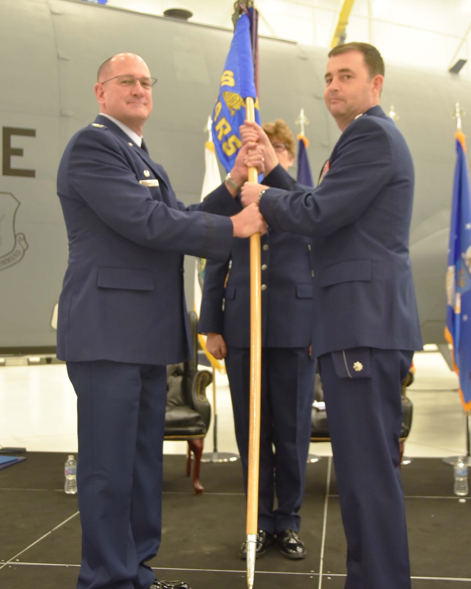 Col. Kevin Rainey, 931st Operations Group commander, gives the guidon to Lt. Col. Stacy Moore, incoming 18th Air Refueling Squadron commander, during a change of command ceremony Dec. 1, 2018, McConnell Air Force Base, Kan.  Prior to this assignment, Moore served as the 931st Operations Support Squadron commander.