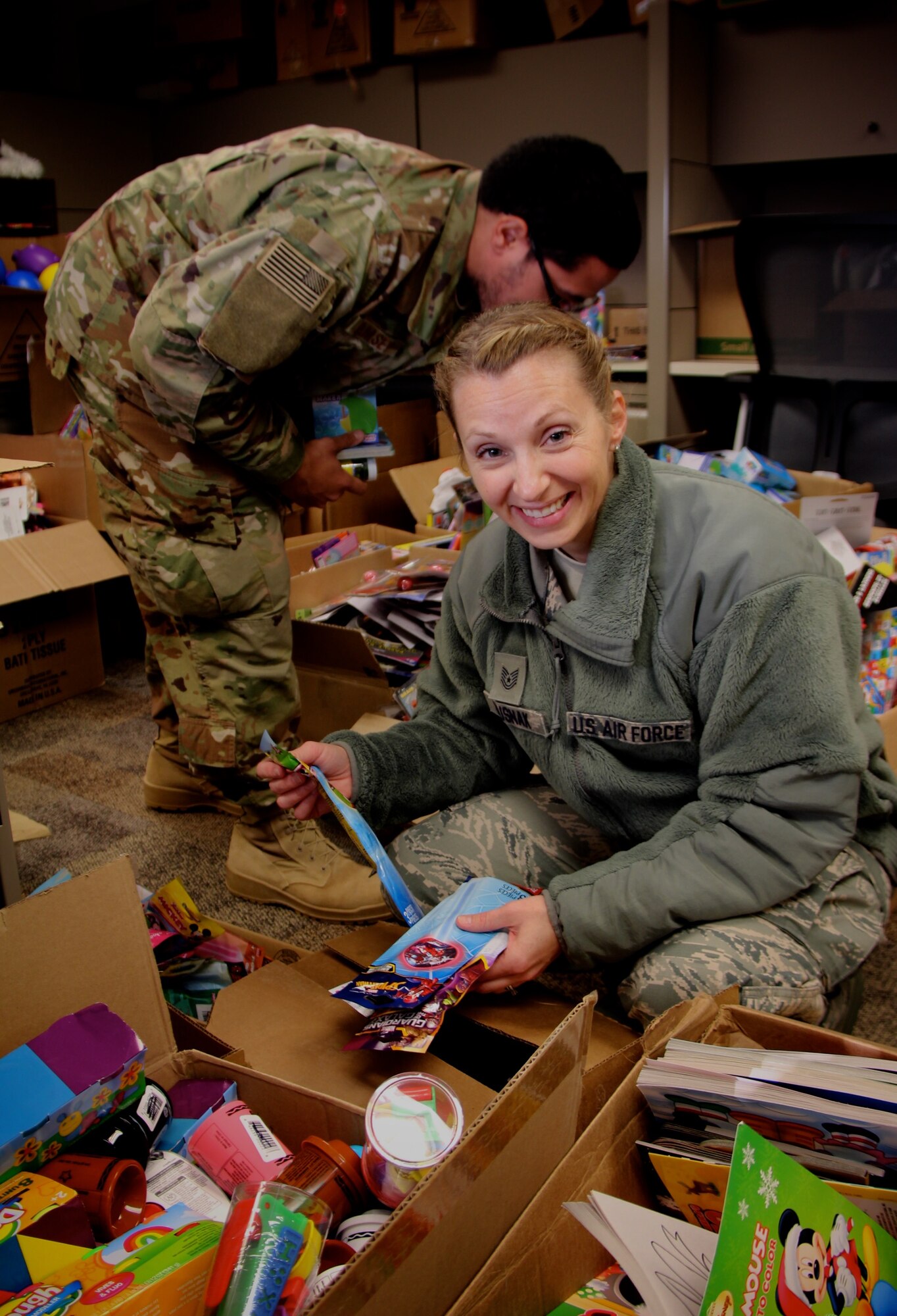 Making her holiday list and checking it twice, Tech Sgt. Teresa Rusnak, picks up the Airman and Family Readiness office's free toy donations for her children.  She is the readiness planner for 932nd Airlift Wing's Inspector General of Inspections at the Illinois unit.  A variety of toys, cookies, and candy are ready to be distributed through the 932nd Airlift Wing Family Readiness Office, led by Deb Teague.  She and other reservists offloaded many parcels of food, toys and cookies recently, on behalf of the Air Force Reserve Command unit located at Scott Air Force Base, Ill. The items will be given out to reservists in Illinois during the December unit training assembly weekend.  (U.S. Air Force photo by Lt. Col. Stan Paregien)