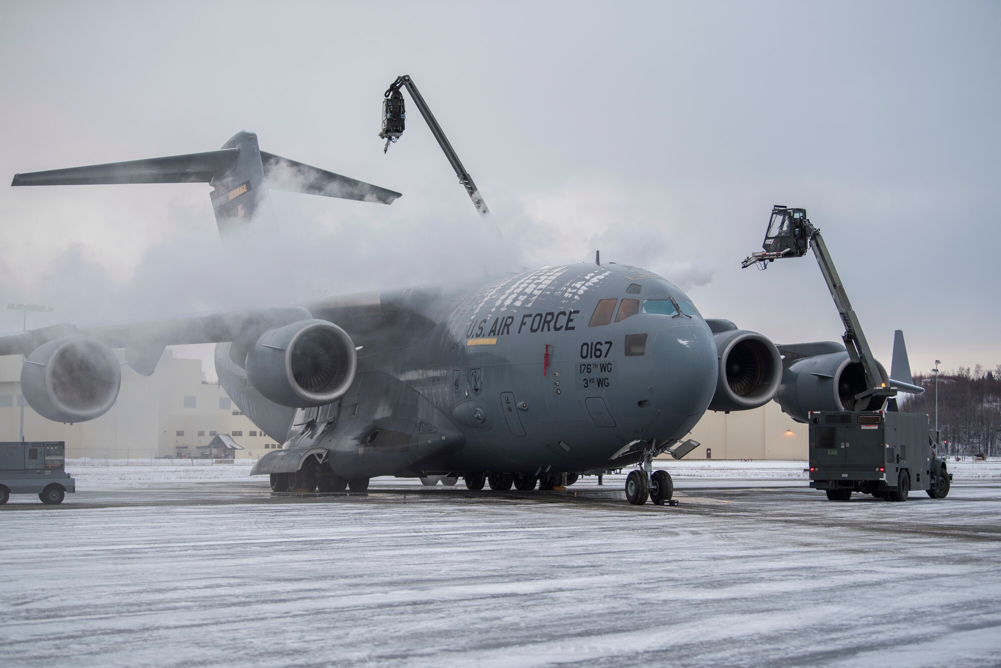 U.S. Air Force Airmen with the 732nd Aircraft Mobility Squadron deices a C-17 Globemaster III at Joint Base Elmendorf-Richardson, Alaska, Dec. 1, 2018. JBER mission operations continue following a 7.0 earthquake hit to Anchorage, Alaska, on Nov. 30.