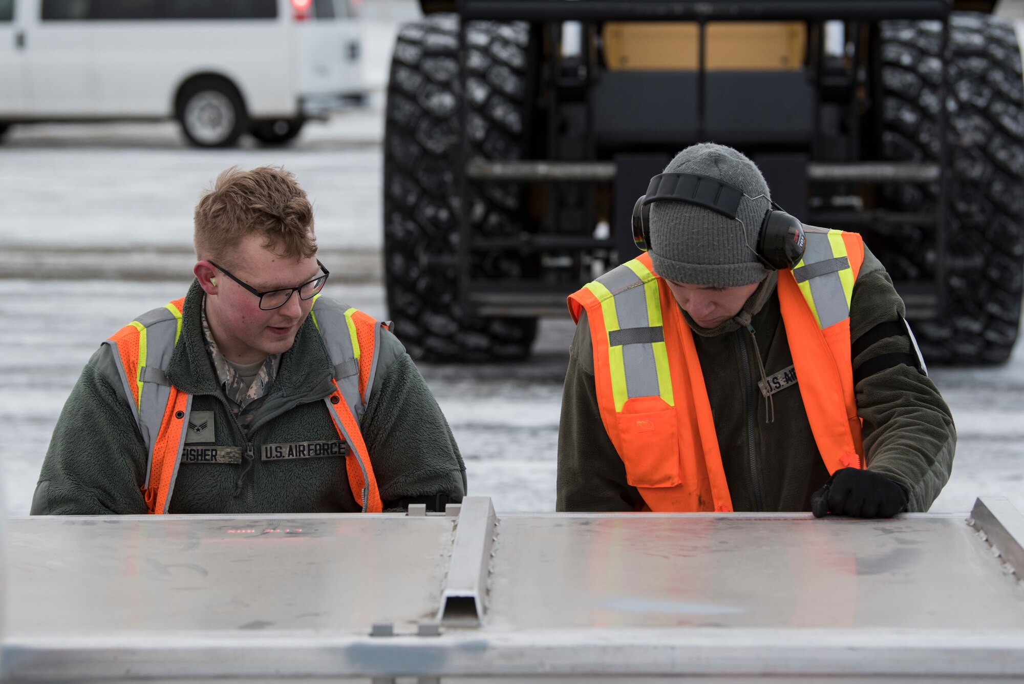 U.S. Air Force Airmen with the 732nd Aircraft Mobility Squadron secure cargo onto a pallet at Joint Base Elmendorf-Richardson, Alaska, Dec. 1, 2018. JBER mission operations continue following a 7.0 earthquake hit to Anchorage, Alaska, on Nov. 30.