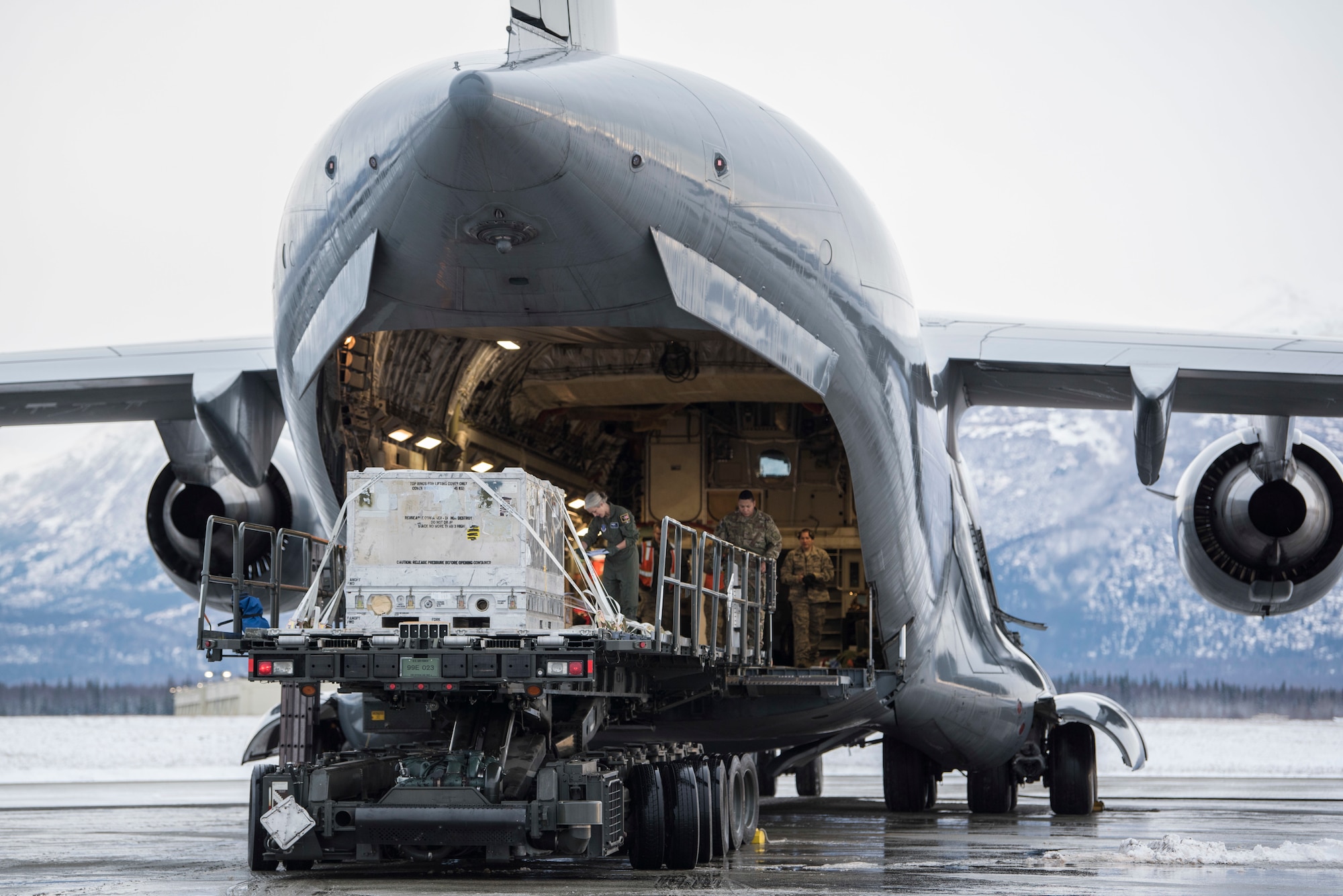 U.S. Air Force Airmen with the 732nd Aircraft Mobility Squadron unload cargo onto a C-17 Globemaster III at Joint Base Elmendorf-Richardson, Alaska, Dec. 1, 2018. JBER mission operations continue following a 7.0 earthquake hit to Anchorage, Alaska, on Nov. 30.