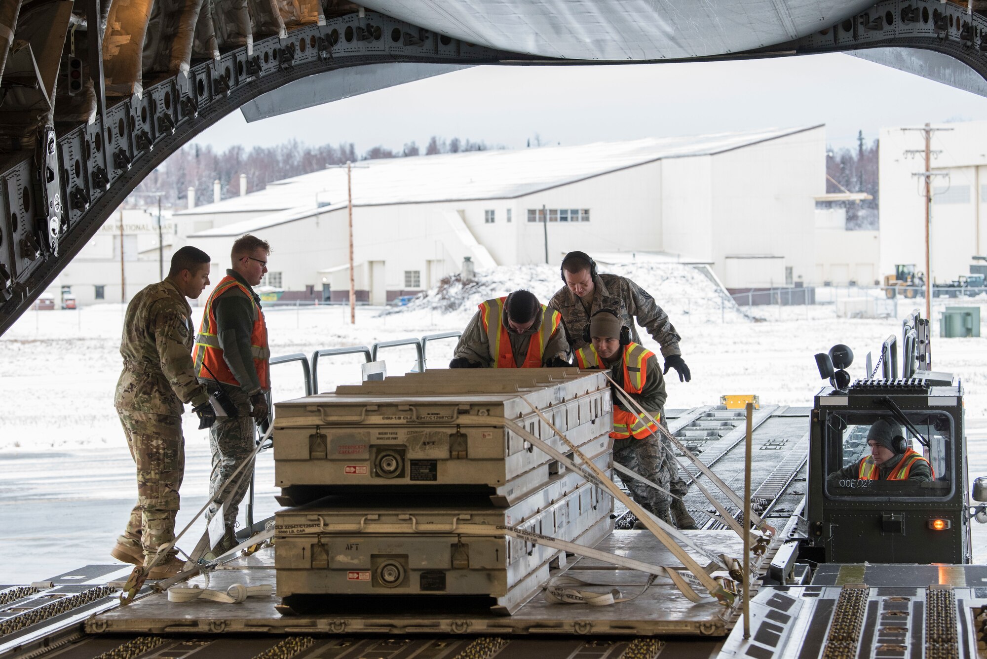 U.S. Air Force Airmen with the 732nd Aircraft Mobility Squadron unload cargo onto a C-17 Globemaster III at Joint Base Elmendorf-Richardson, Alaska, Dec. 1, 2018. JBER mission operations continue following a 7.0 earthquake hit to Anchorage, Alaska, on Nov. 30.