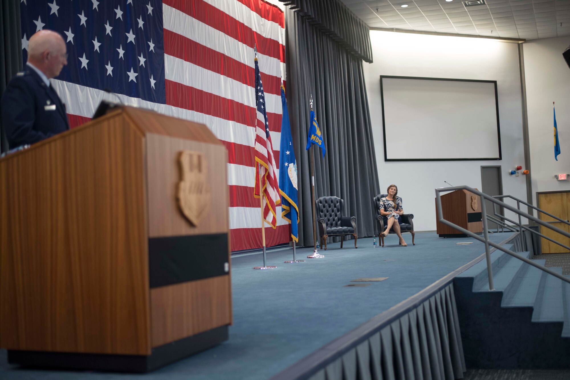 Dr. Tess VanHoy, 307th Medical Squadron honorary commander, looks on as Col. Louis Fehl, 307th MDS commander, speaks during an induction ceremony at Barksdale Air Force Base, Louisiana, Dec. 1, 2018.  VanHoy became the first honorary commander of the unit during the induction ceremony.  She is a medical doctor with several years of experience and is the spouse of Col. Rober VanHoy, 307th Bomb Wing commander. (U.S. Air Force photo by Master Sgt. Ted Daigle)