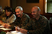 Marine Col. Vincent Ciuccoli, left, and Marine Col. David Steele listen during a meeting Nov. 29 at Terra Restaurant aboard Camp Foster, Okinawa, Japan.