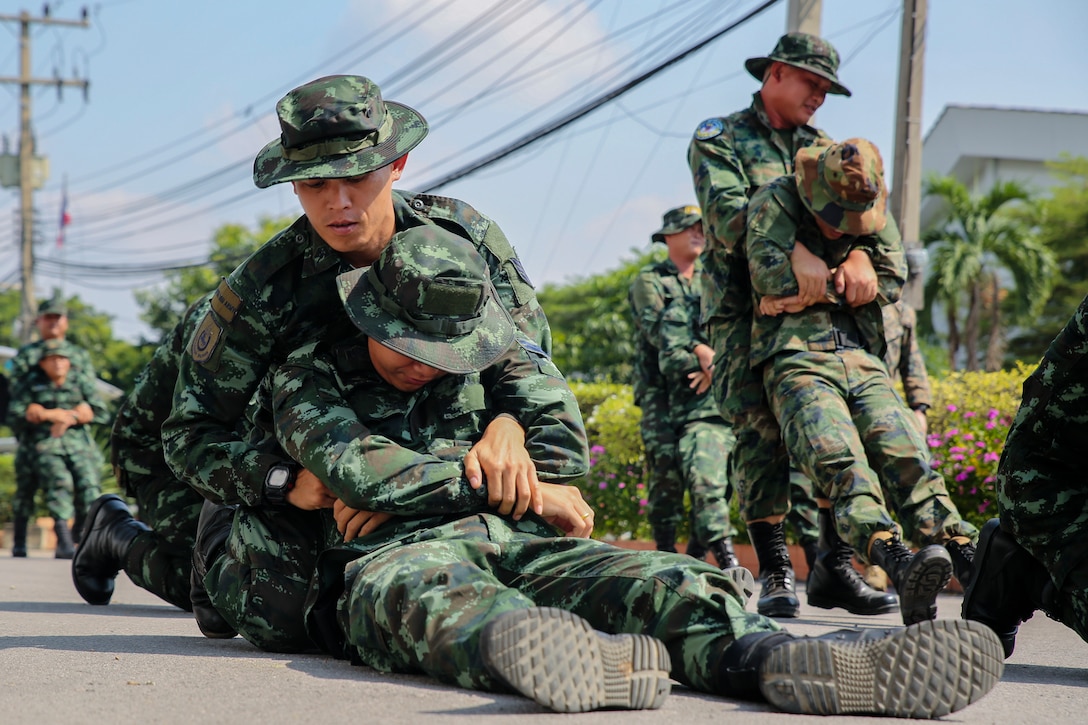Service members with the Royal Thai Armed Forces move simulated casualties during a demining training event at the Panurangsri Camp Military Engineer Department in Ratchaburi, Kingdom of Thailand, Nov. 19, 2018. Service members with the Royal Thai Armed Forces work with U.S. Marine explosive ordnance disposal technicians, engineers and corpsmen with 9th Engineer Support Battalion, 3rd Marine Logistics Group, to build up the Thai military’s demining capabilities and supplemental combat casualty care skills. The Marine Corps conducts multiple Humanitarian Mine Action training packages with partner nations annually, instructing military students on the tactics, techniques and procedures for locating, removing and disposing of unexploded ordnance.