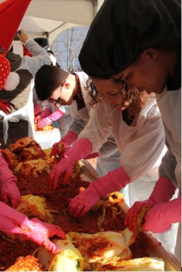 SEONGNAM, Republic of Korea – U.S. Marines Corps Forces Korea and Republic of Korea government organizations, private entities, and citizens season cabbage during Kimchi Fest here, Nov. 30.  The Department of Agriculture, Food and Rural Affairs; Asia Leaders Forum for Science; and MARFORK put together the Kimchi Fest to make Kimchi for elderly and less fortunate Koreans.