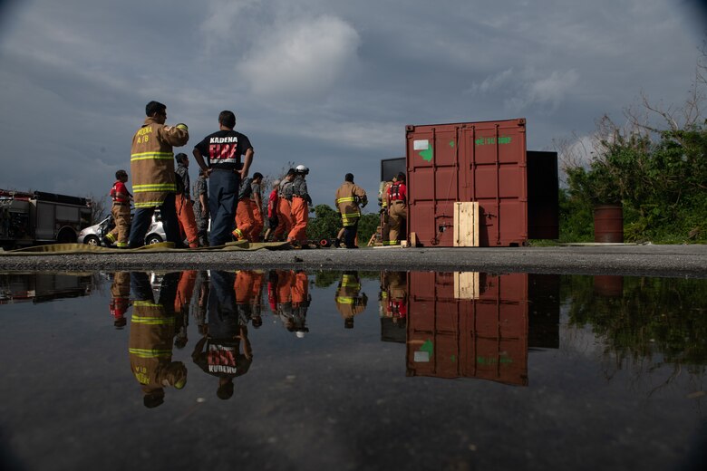 U.S. Air Force firefighters from the 18th Civil Engineer Squadron and Japan Air Self Defense Force firefighters from the 9th Wing, Naha Air Base, Japan, conduct a walk through before structural live fire training Nov. 15, 2018, at Kadena Air Base, Japan. The training enabled both units to hone their techniques, meet annual requirements, develop communication skills and foster team building. (U.S. Air Force photo by Staff Sgt. Micaiah Anthony)