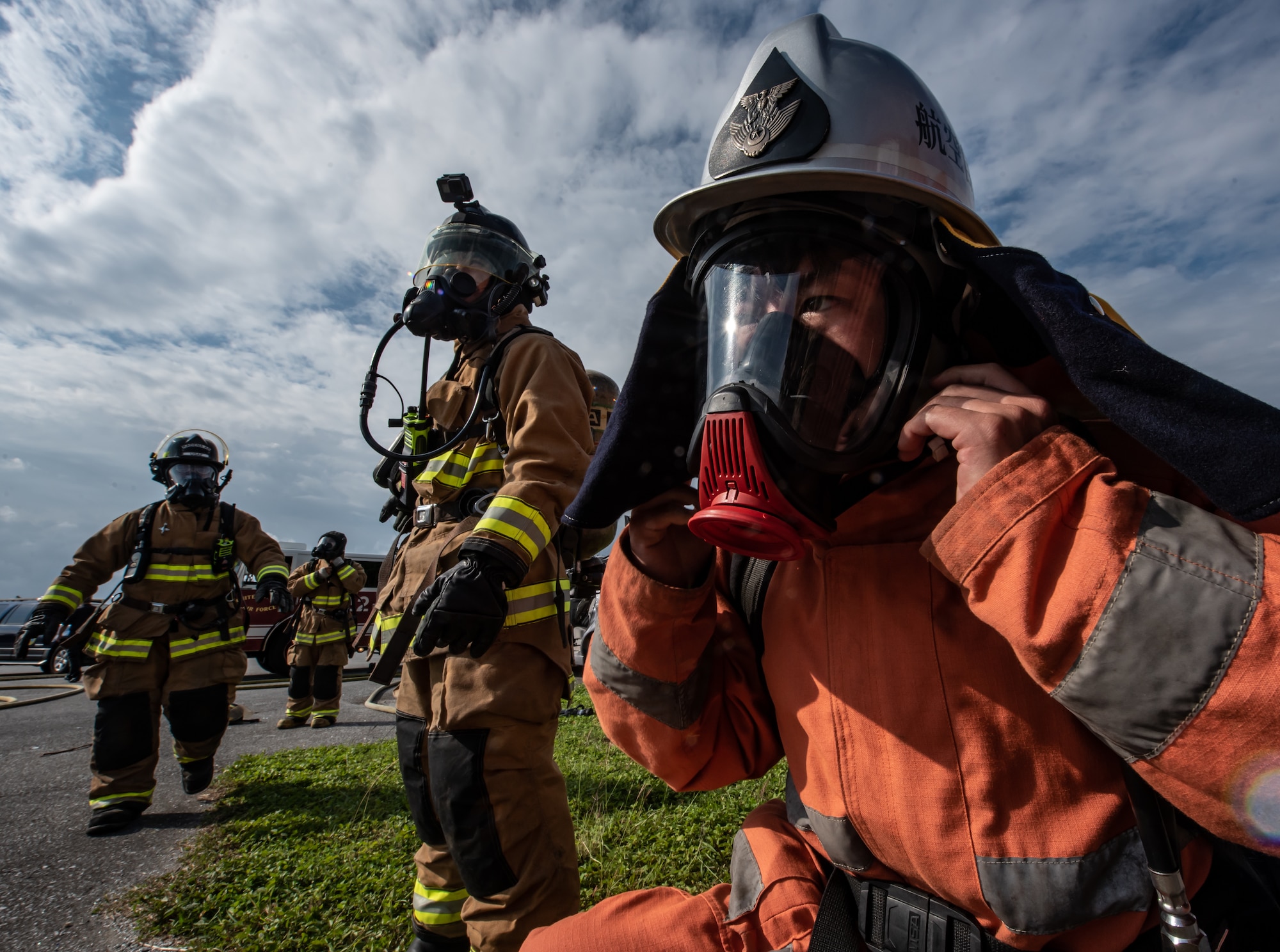 A Japan Air Self Defense Force firefighter from the 9th Wing, Naha Air Base, Japan, dons firefighting equipment Nov. 15, 2018, at Kadena Air Base, Japan. Firefighters conduct training regularly to maintain constant readiness for emergencies. (U.S. Air Force photo by Staff Sgt. Micaiah Anthony)