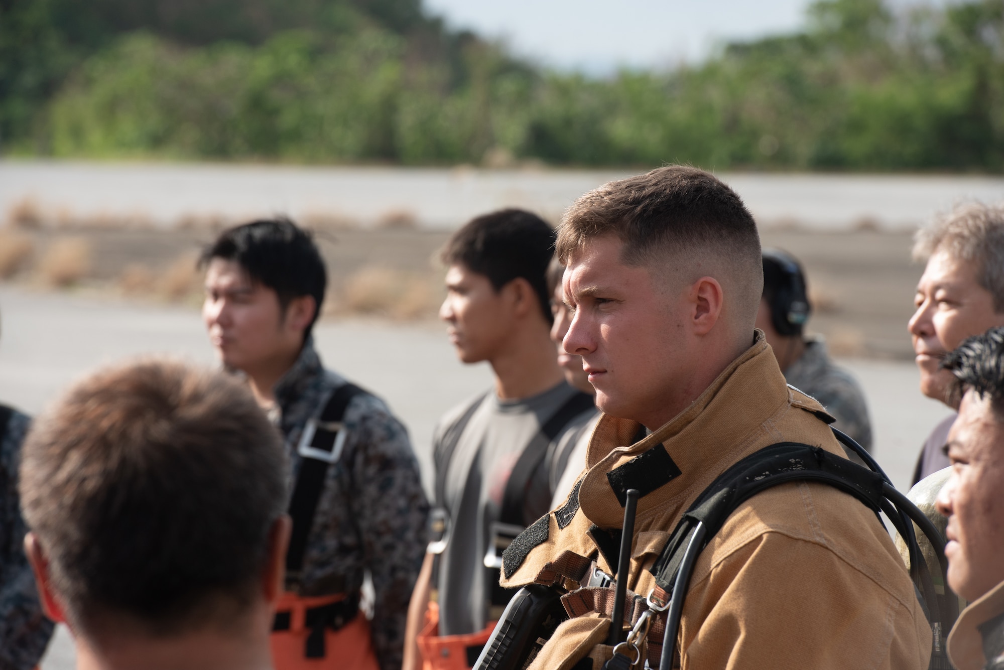 U.S. Air Force firefighters from the 18th Civil Engineer Squadron and Japan Air Self Defense Force firefighters from the 9th Wing, Naha Air Base, Japan, listen to a briefing Nov. 15, 2018, at Kadena Air Base, Japan. Firefighters conduct training regularly to maintain constant readiness for emergencies. (U.S. Air Force photo by Staff Sgt. Micaiah Anthony)