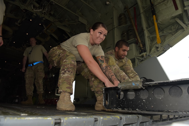 U.S. Air Force Senior Airman Tori Watts and Senior Airman Micheal Ricci, 100th Logistics Readiness Squadron fuels distribution drivers and 67th Special Operations Squadron Forward Arming and Refueling Point team members, lift a refueling hose rack onto a CV-22 Osprey for a FARP mission at RAF Mildenhall, England, Oct. 11, 2018. The 100th LRS and the 67th SOS have teams of fuels Airmen who provide a critical capability for wartime and humanitarian missions. (U.S. Air Force photo by Airman 1st Class Alexandria Lee)