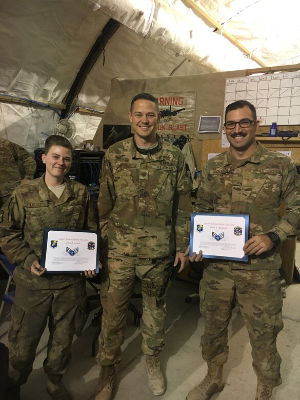 Maj. Michael Lasher (center), 451st Expeditionary Aircraft Maintenance Squadron commander, notifies Airman 1st Class Gina Louise and Airman 1st Class Dane Richards of their promotion to Senior Airman “Below the Zone” at Kandahar Airfield, Afghanistan. (courtesy photo)