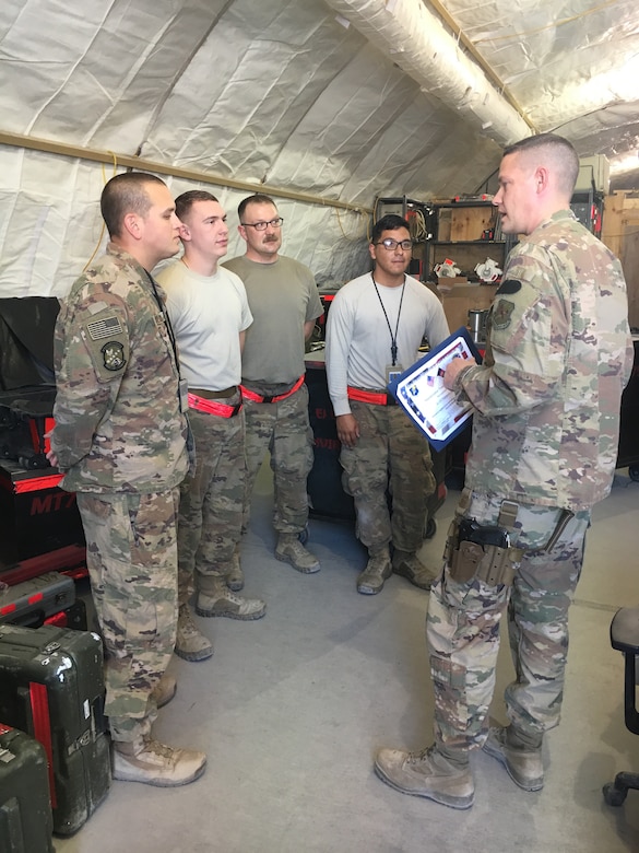 Maj. Michael Lasher, 451st EAMXS commander, presents the Team of the Month certificate to members of the A-10 Support Section: (left to right) Master Sgt. Alex Goolsby, Airman 1st Class Austin Jones, Staff Sgt. Adam Buehler and Airman 1st Class Brandon Mendoza, at Kandahar Airfield, Afghanistan. (courtesy photo)