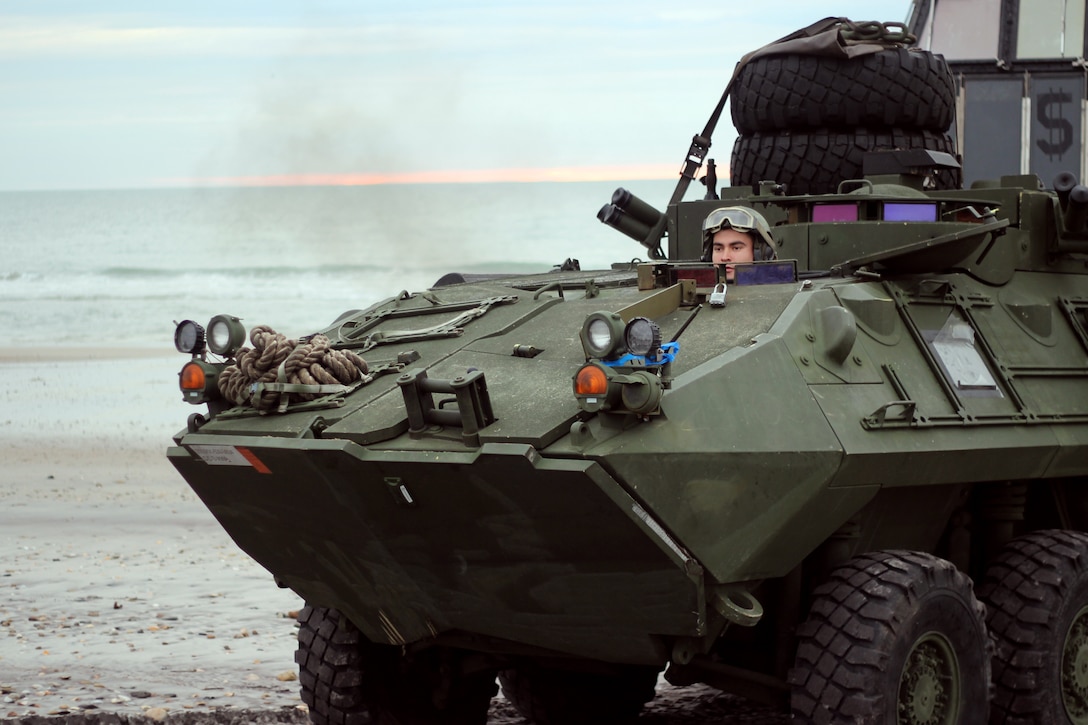 A Marine guides a light armored vehicle onto Onslow Beach, Camp Lejeune, North Carolina, Nov. 30, 2018.