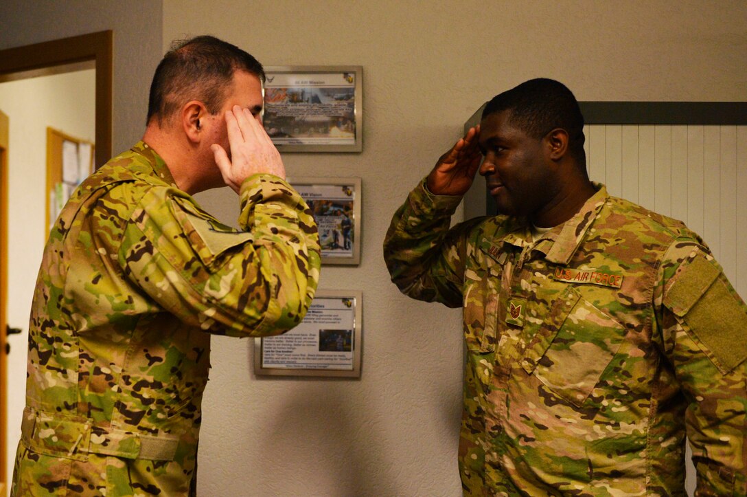 U.S. Air Force Tech. Sgt. Fritz Julian, 86th Comptroller Squadron budget analyst, right, receives recognition from Brig. Gen. Mark August, 86th Airlift Wing commander, on Ramstein Air Base, Germany, Nov. 30, 2018. Julian was lauded by the 86th AW’s command team for his efforts in supporting the Air Force mission in Europe. (U.S. Air Force photo by Senior Airman Joshua Magbanua)