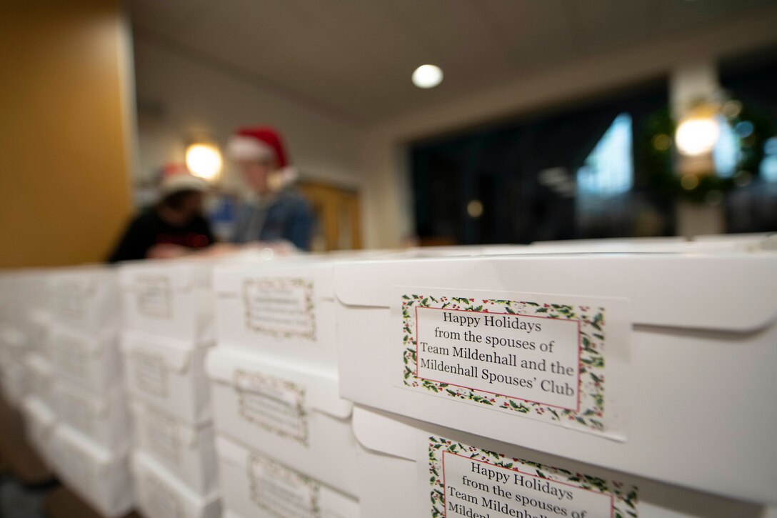 Members of the Team Mildenhall Spouses Club collected and packed boxes of cookies during the annual RAF Mildenhall Cookie Drive in the chapel at RAF Mildenhall, England, Dec. 3, 2018. The cookie donations were packed and distributed to Airmen in the dorms by Team Mildenhall leadership. (U.S. Air Force photo by Senior Airman Luke Milano)