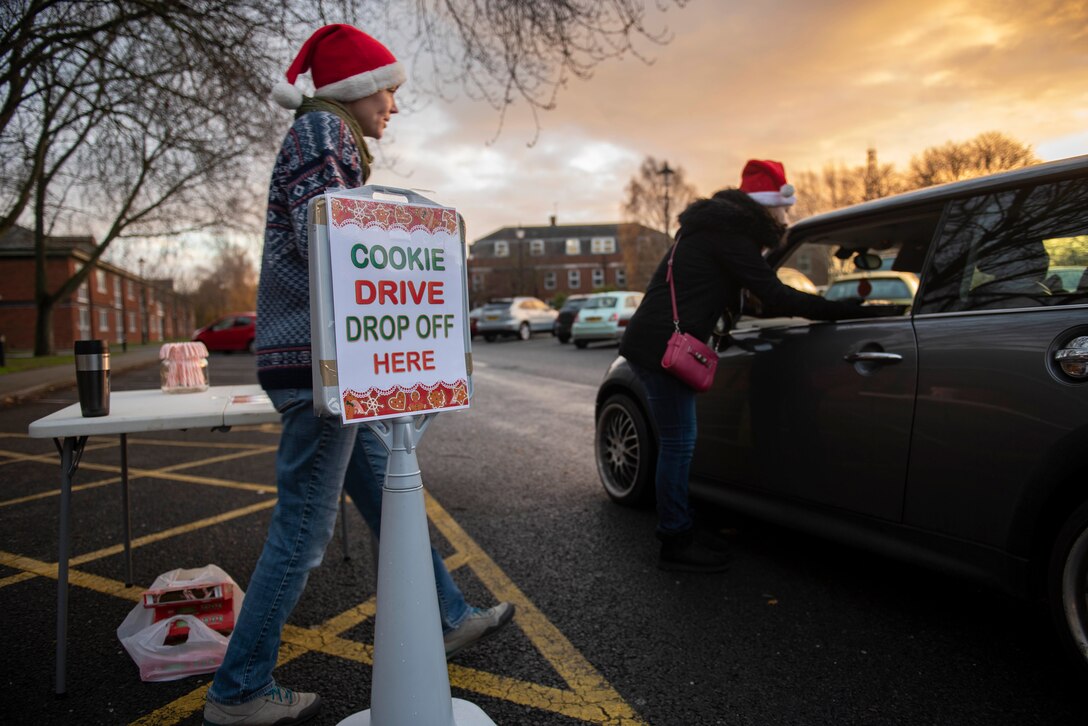 Members of the Team Mildenhall spouses club collect cookies for the annual RAF Mildenhall Cookie Drive at the base chapel on RAF Mildenhall, England, Dec. 3, 2018.  Team Mildenhall Airmen and families donated cookies for Airmen who live in the dorms. (U.S. Air Force photo by Senior Airman Luke Milano)
