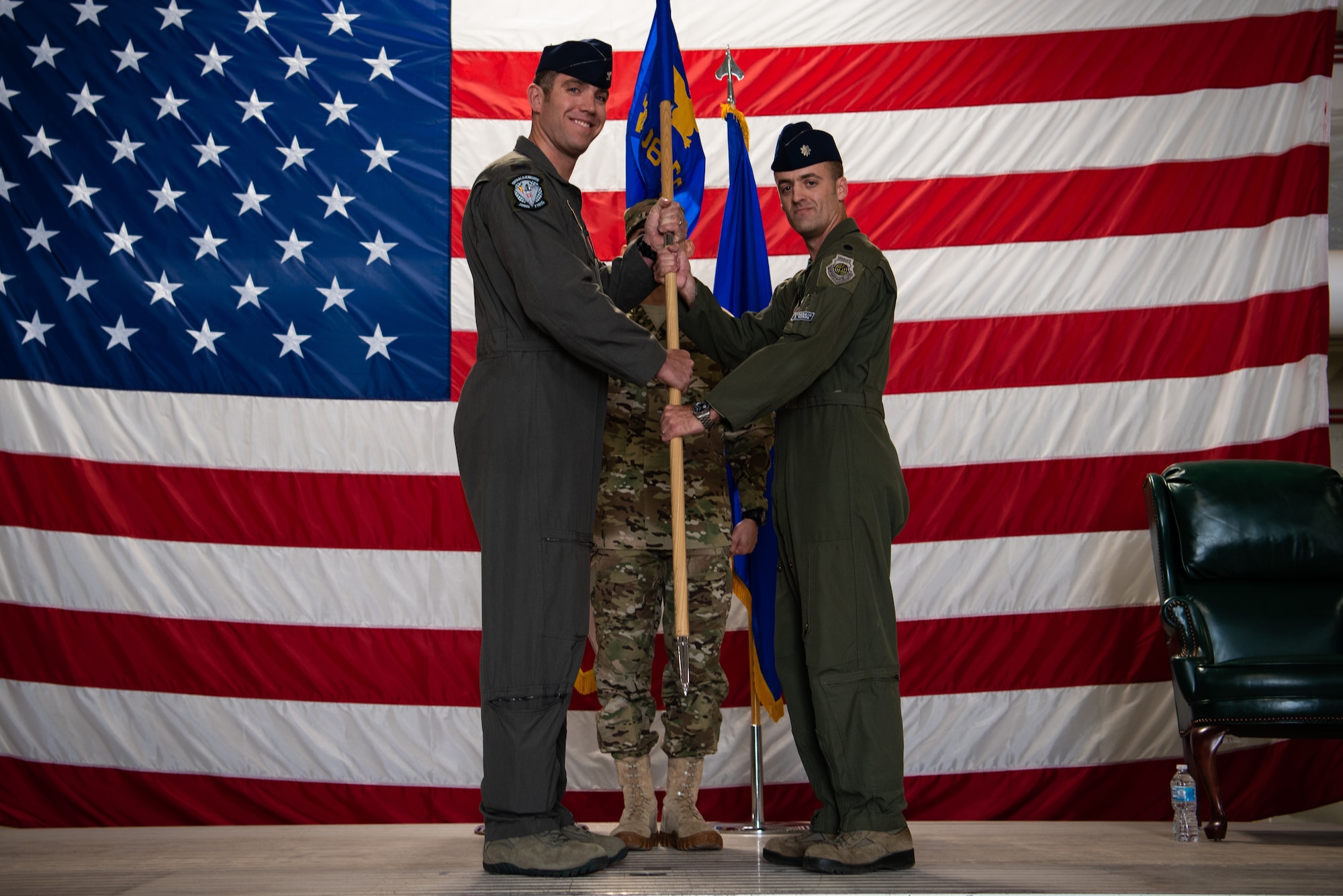 Col. Mathew Renbarger, 56th Operations Group commander, passes the 308th Fighter Squadron guidon to Lt. Col. Robert Miller, 308th Fighter Squadron commander, during an assumption of command ceremony, Nov. 30, 2018 at Luke Air Force Base, Ariz.