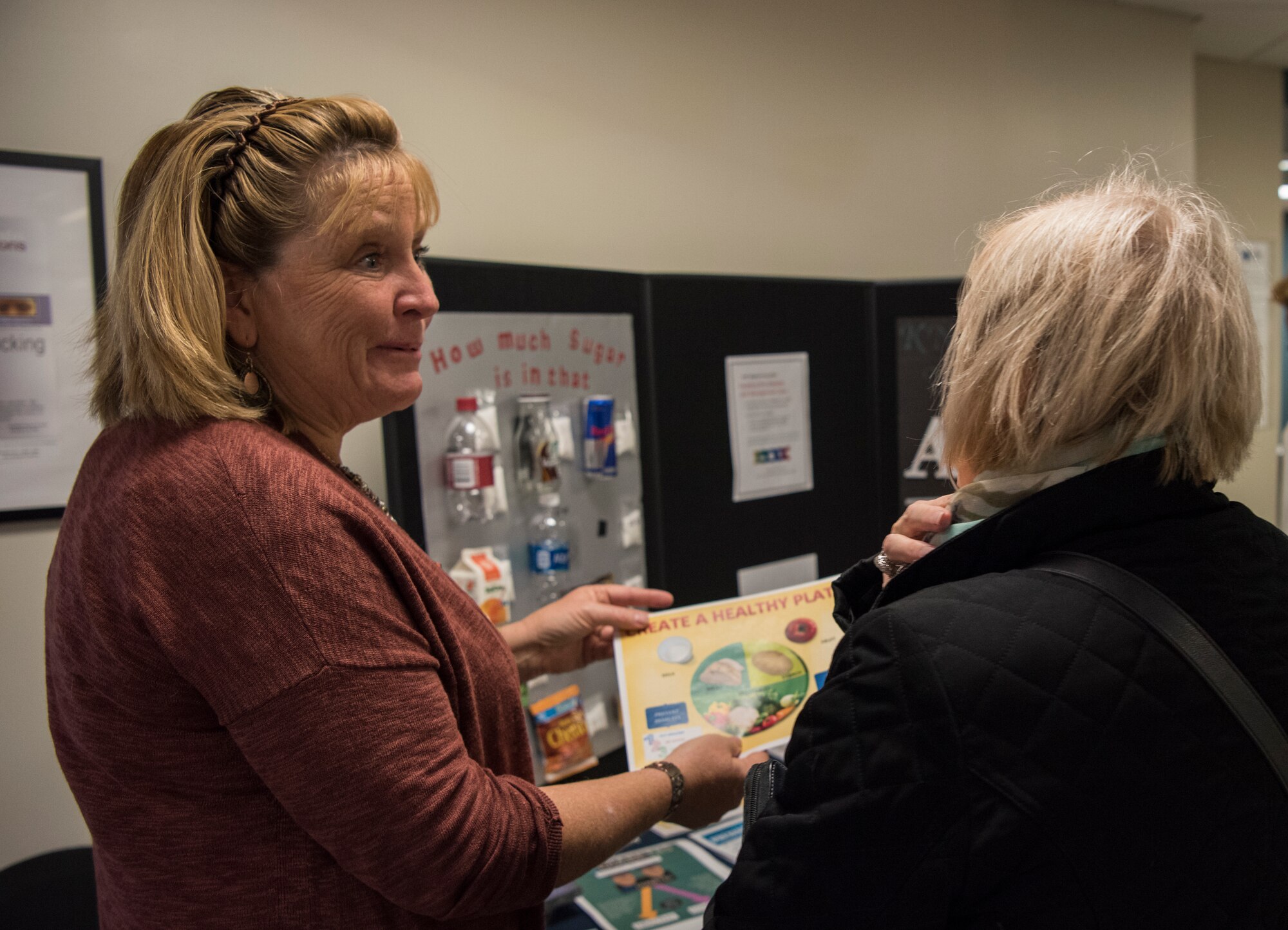 Teresa Dunn, 436th Medical Group disease management nurse, speaks with an attendee during the Health Fair hosted by the 436th Medical Group Nov. 27, 2018, at Dover Air Force Base, Del. The event included a variety of booths including the Airman and Family Readiness Center, Humana, Public Health, Dental Health and Diabetes and Pre-diabetes information. (U.S. Air Force photo by Airman 1st Class Zoe M. Wockenfuss)