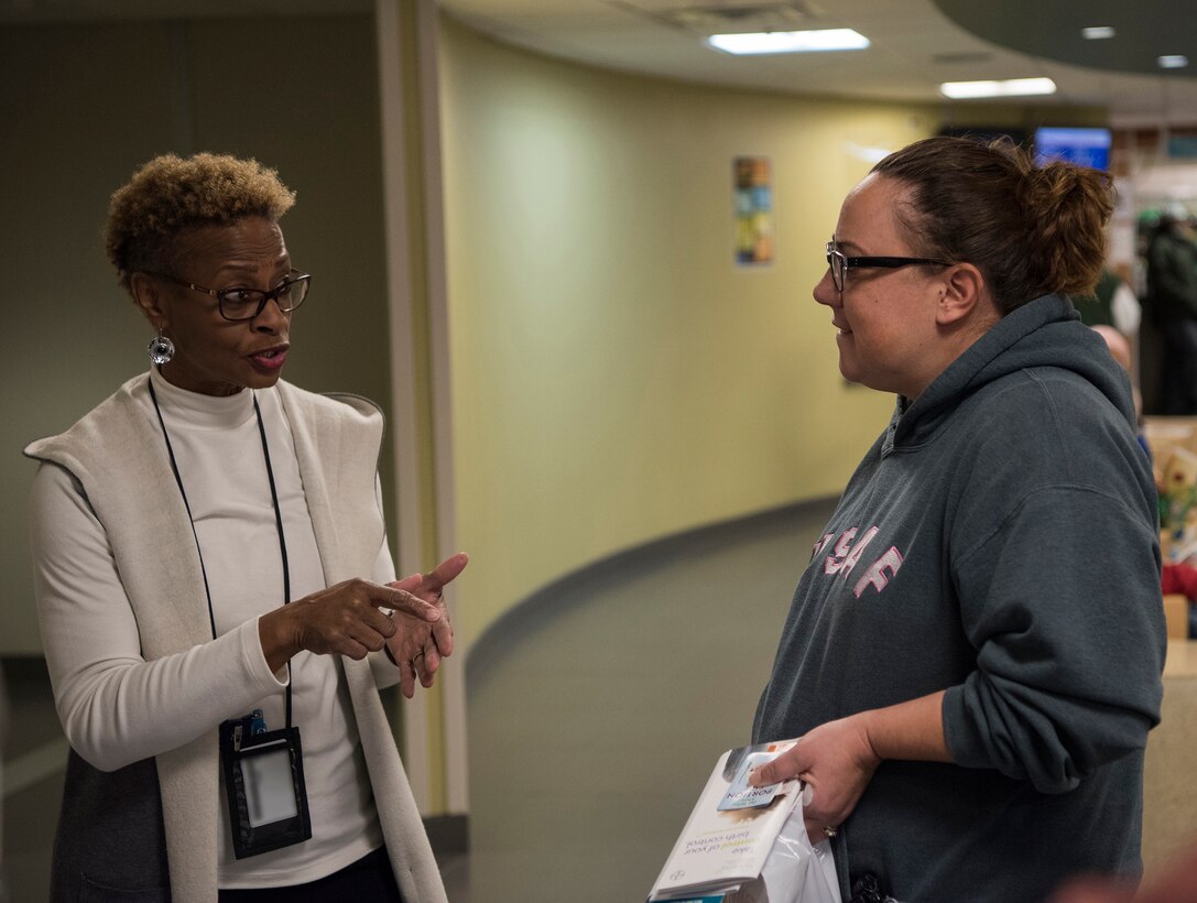 Gabriella Dillard, 436th Medical Group disease management nurse, speaks with Angela Guild, a health fair attendee, during the 436th Medical Group Health Fair on Nov. 27, 2018, at Dover Air Force Base, Del. The event included a variety of booths including the Airman and Family Readiness Center, Humana, Public Health, Dental Health and Diabetes and Pre-diabetes information. (U.S. Air Force photo by Airman 1st Class Zoe M. Wockenfuss) (This image has been obscured to protect personal identification information)