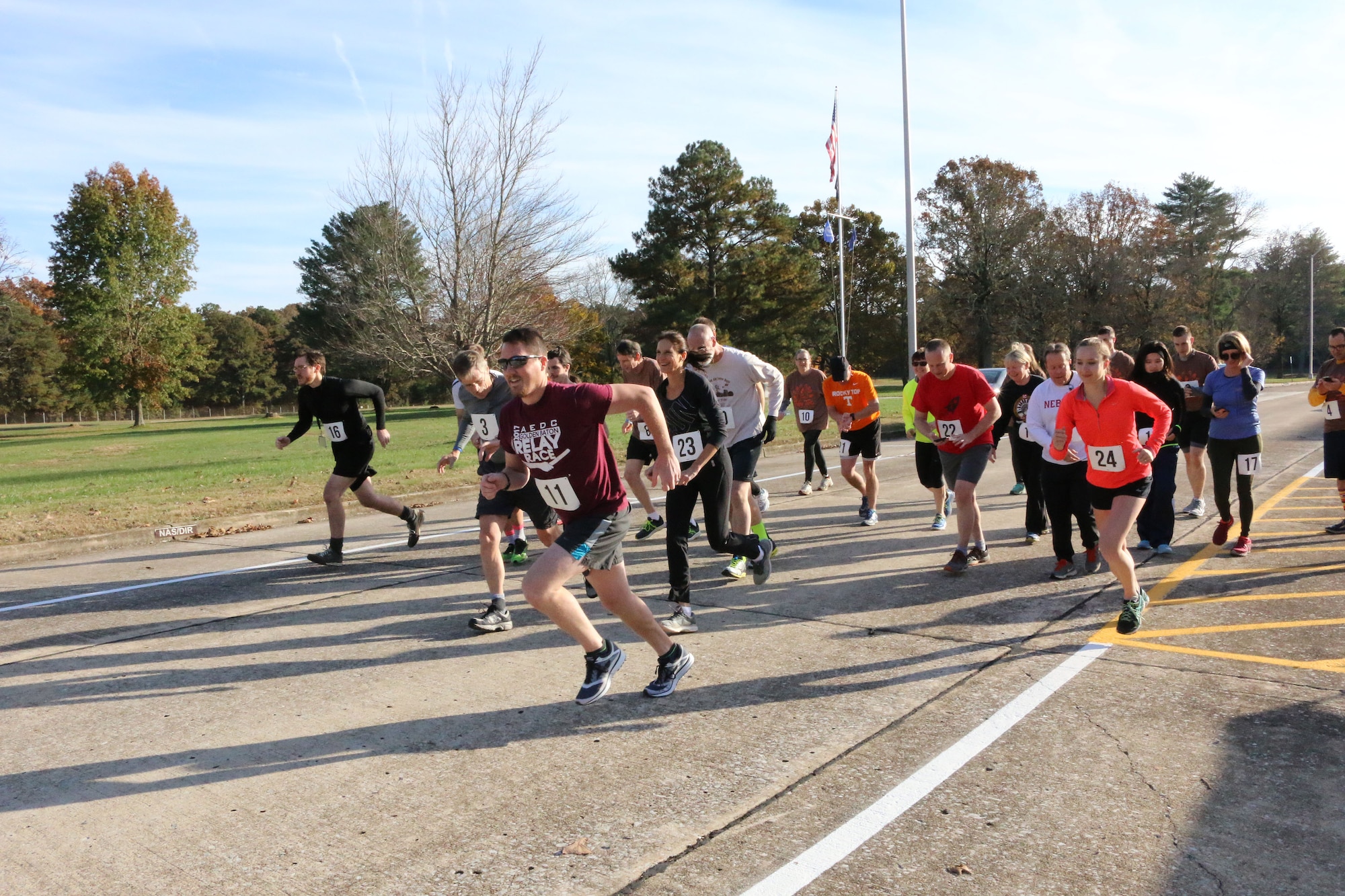 Runners taking part in the 33rd Annual AEDC Turkey Trot bolt from the starting line. The 5K, which was held on Nov. 16, began in front of the Administration & Engineering Building at Arnold Air Force Base, took runners around Kindel Drive, onto the base Fitness Trail and back around Kindel Drive to finish back at the A&E Building. (U.S. Air Force photo by Brad Hicks) (Image was altered by obscuring badges for security purposes)
