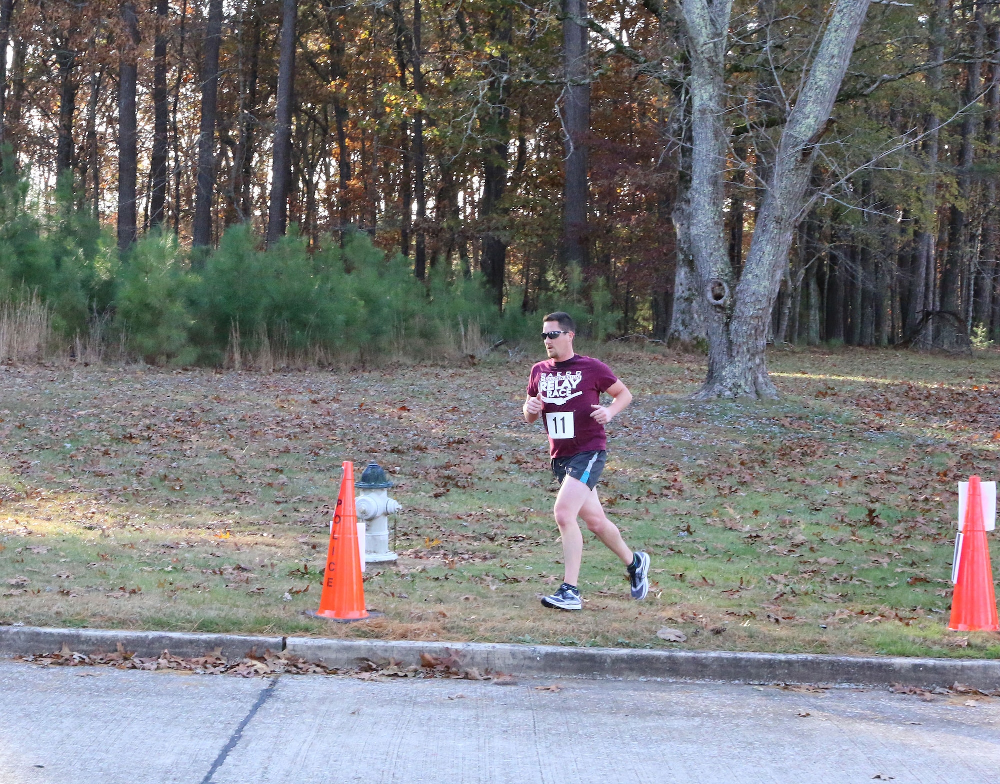 Paul Wright, program manager in Arnold Air Force Base Capital Improvements, exits the base Fitness Trail as he makes a push for the finish line during the 33rd Annual AEDC Turkey Trot. Wright finished the 5K first overall with a time of 22 minutes 11 seconds. (U.S. Air Force photo by Brad Hicks)