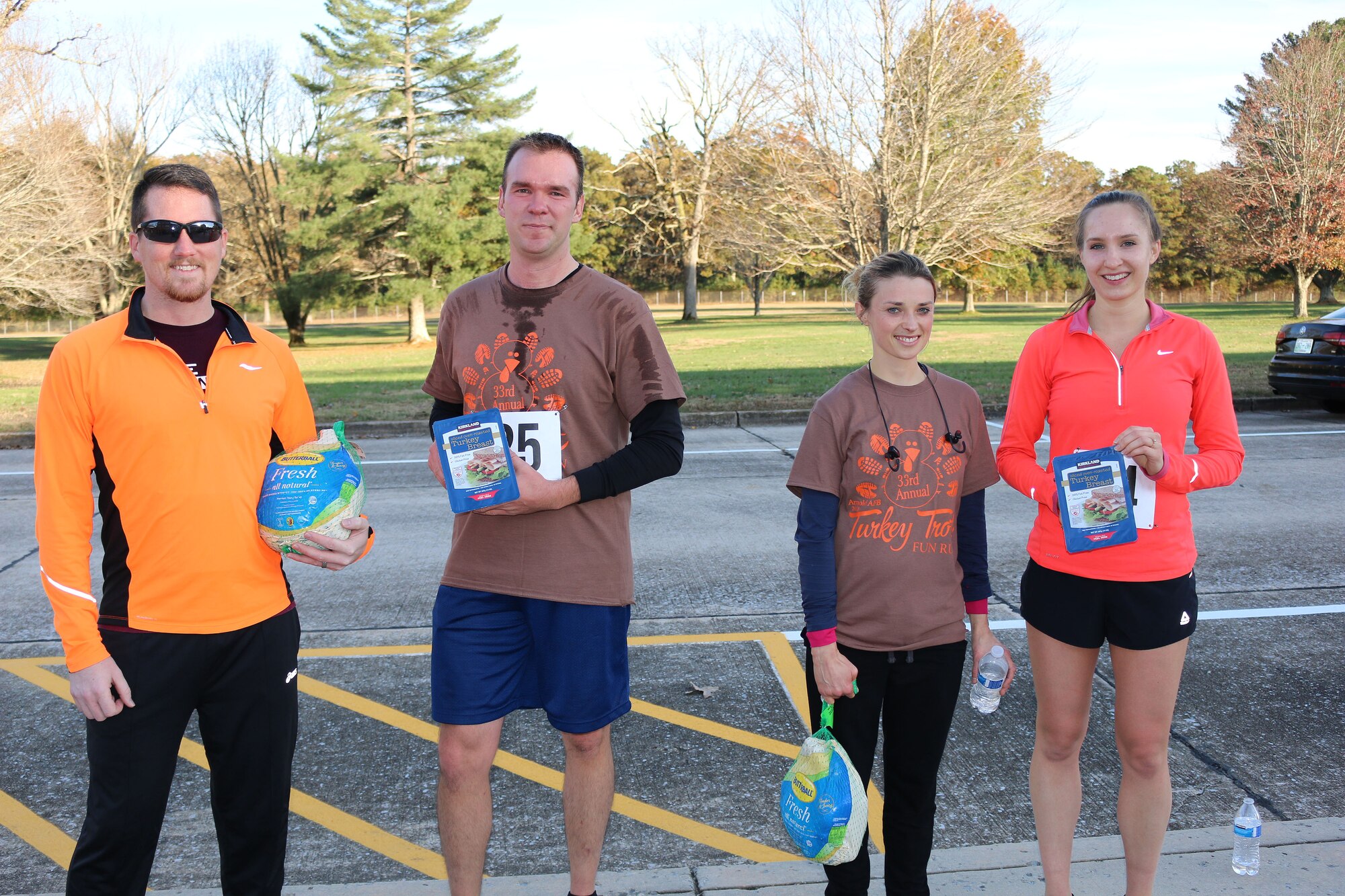 The top two AEDC Turkey Trot finishers from each group pose with their prizes. Pictured from left is Paul Wright, who finished first overall, 1st Lt. Johnathan Gutierrez, who finished second among male runners, Johanna Hay, who placed first among female runners and finished the race second overall, and Laura Burke, who finished second among female runners and third overall. (U.S. Air Force photo by Brad Hicks)