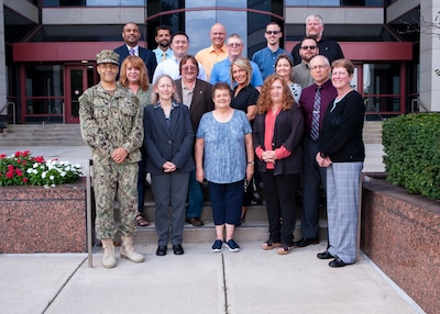 group picture of the Maritime Aircraft Launch and Recovery Equipment Team in front of building 20