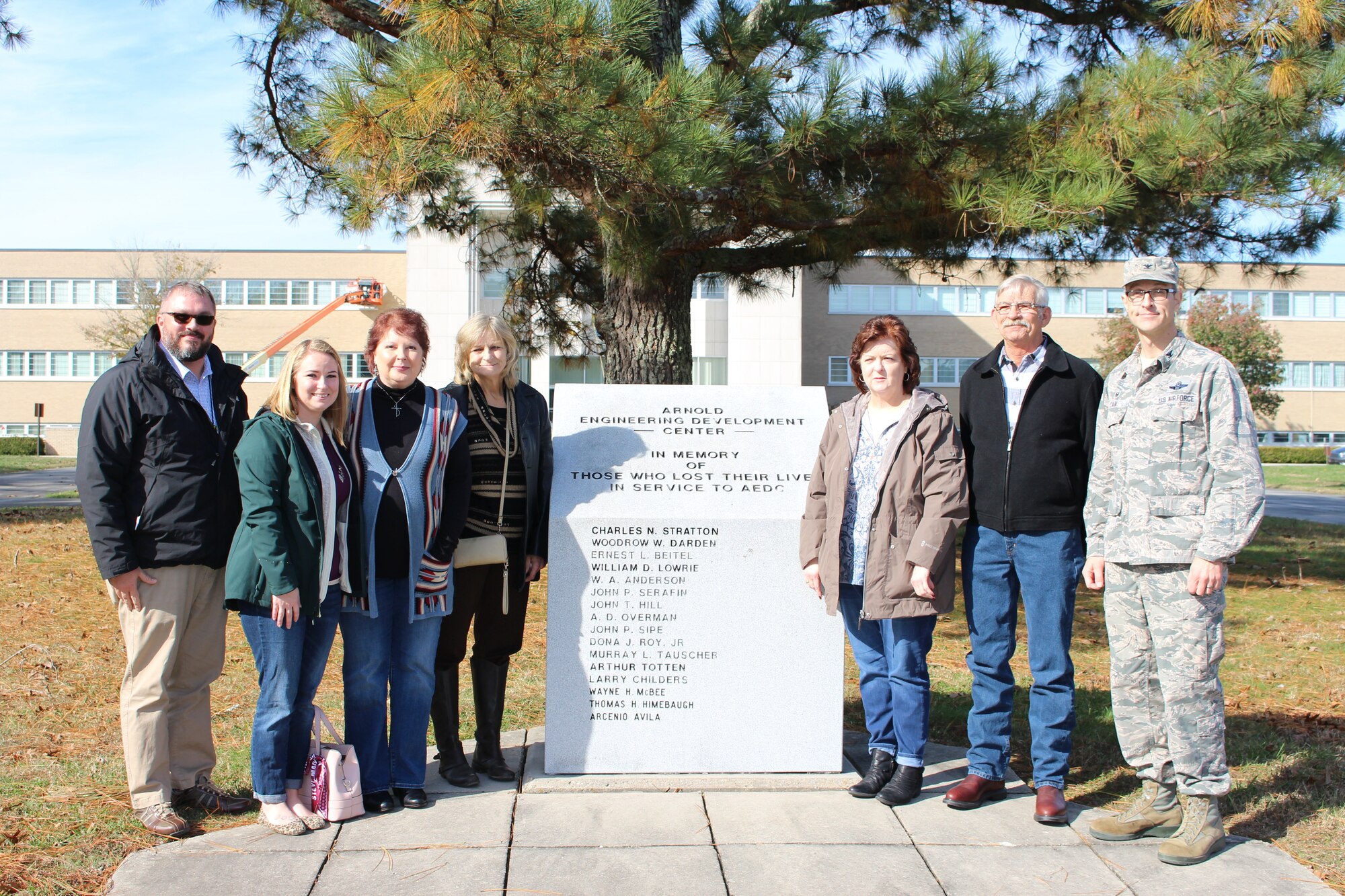 The family of the late Wilmer Adam Anderson, an AEDC concrete laborer, visited Arnold Air Force Base on Nov. 16 to see the memorial outside the Administration and Engineering Building that is dedicated to individuals who have lost their lives in service to AEDC. Anderson was among four AEDC team members who tragically lost their lives in an accident Dec. 17, 1962, at the J-4 liquid rocket test cell. Pictured left to right: Chris Warner, operations chief of AEDC Public Affairs; Julie Gesell; Bridgette Boner; Melissa Gesell; Marilyn Anderson Morton; Danny Anderson; and AEDC Commander Col. Cain. (U.S. Air Force photo by Deidre Ortiz)