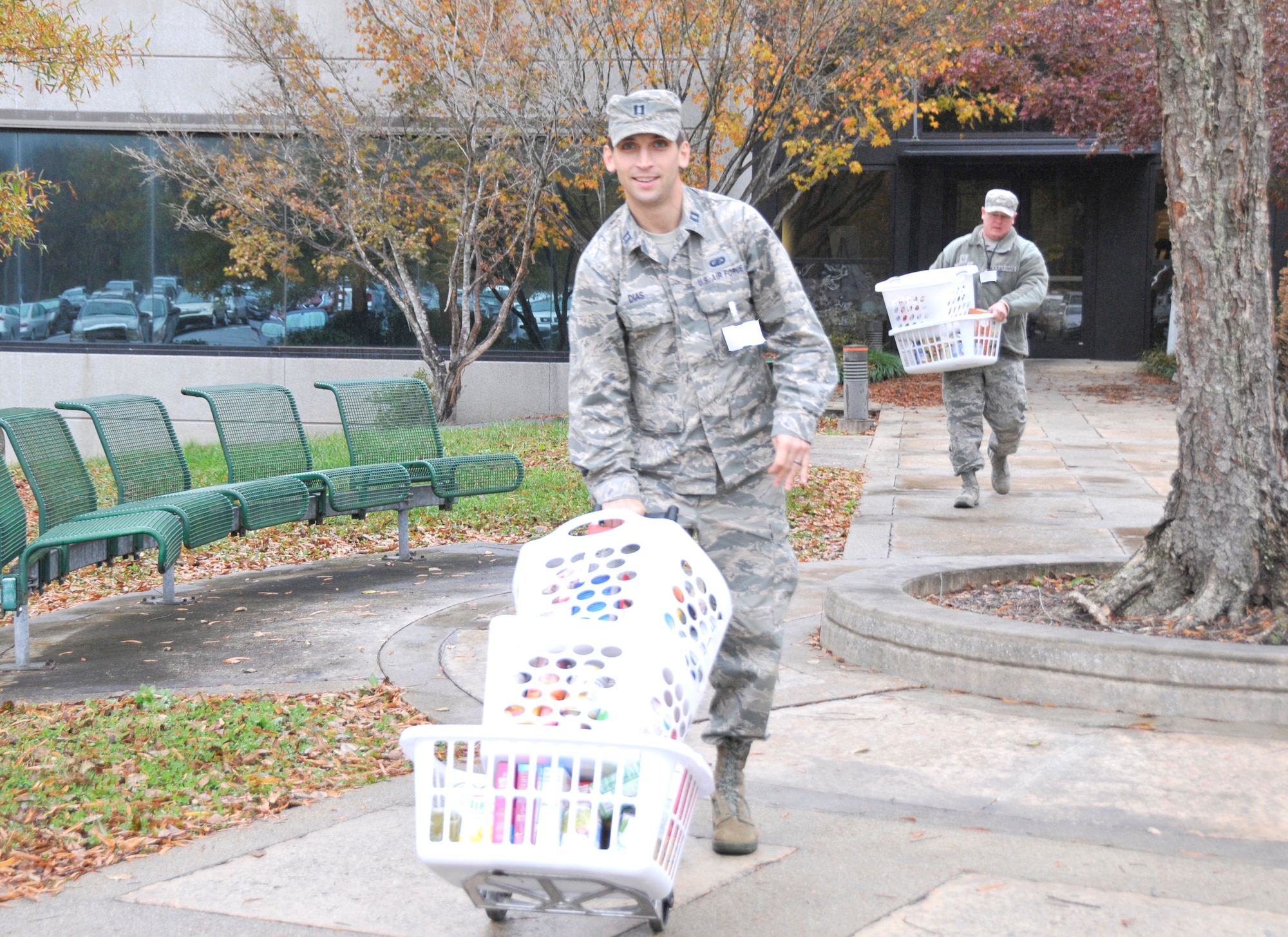 Capt. Jonathon Dias, pictured front, and Master Sgt. Jason Knipe help load baskets of food donated as part of the Thanksgiving Food Basket Program at Arnold Air Force Base. With help from AEDC team members across base, members of the Junior Force Council at Arnold collected donations for 51 food baskets for Coffee County families in need of Thanksgiving meals. (U.S. Air Force photo by Deidre Ortiz)