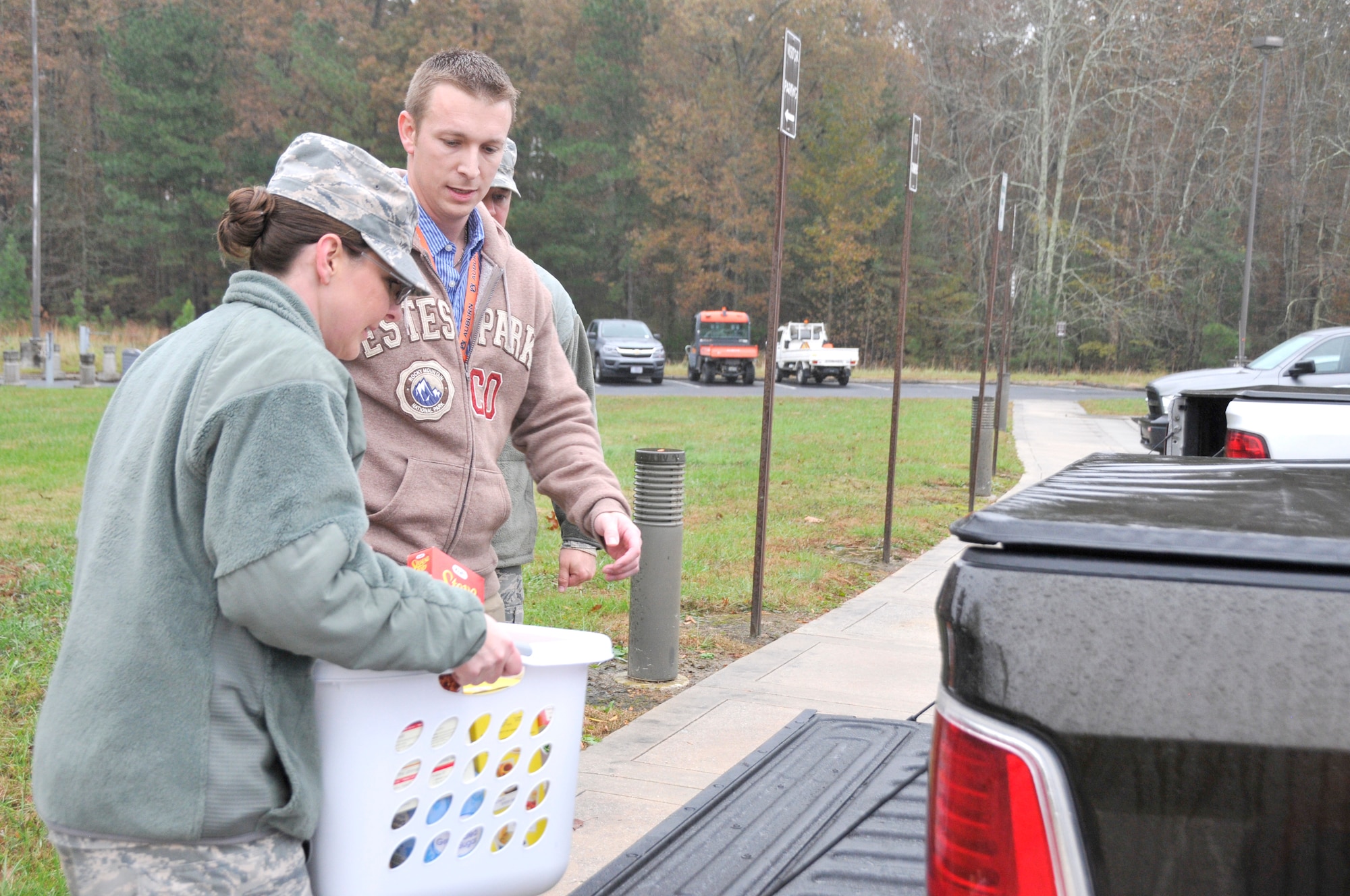 Stephen Maccarino assists 1st Lt. Karlie Madden in loading one of the food baskets donated as part of the Junior Force Council’s Thanksgiving Food Basket Program. With help from AEDC team members across base, JFC members at Arnold collected donations for 51 food baskets for Coffee County families in need of Thanksgiving meals, surpassing the number of baskets that have been collected in years past. (U.S. Air Force photo by Deidre Ortiz)