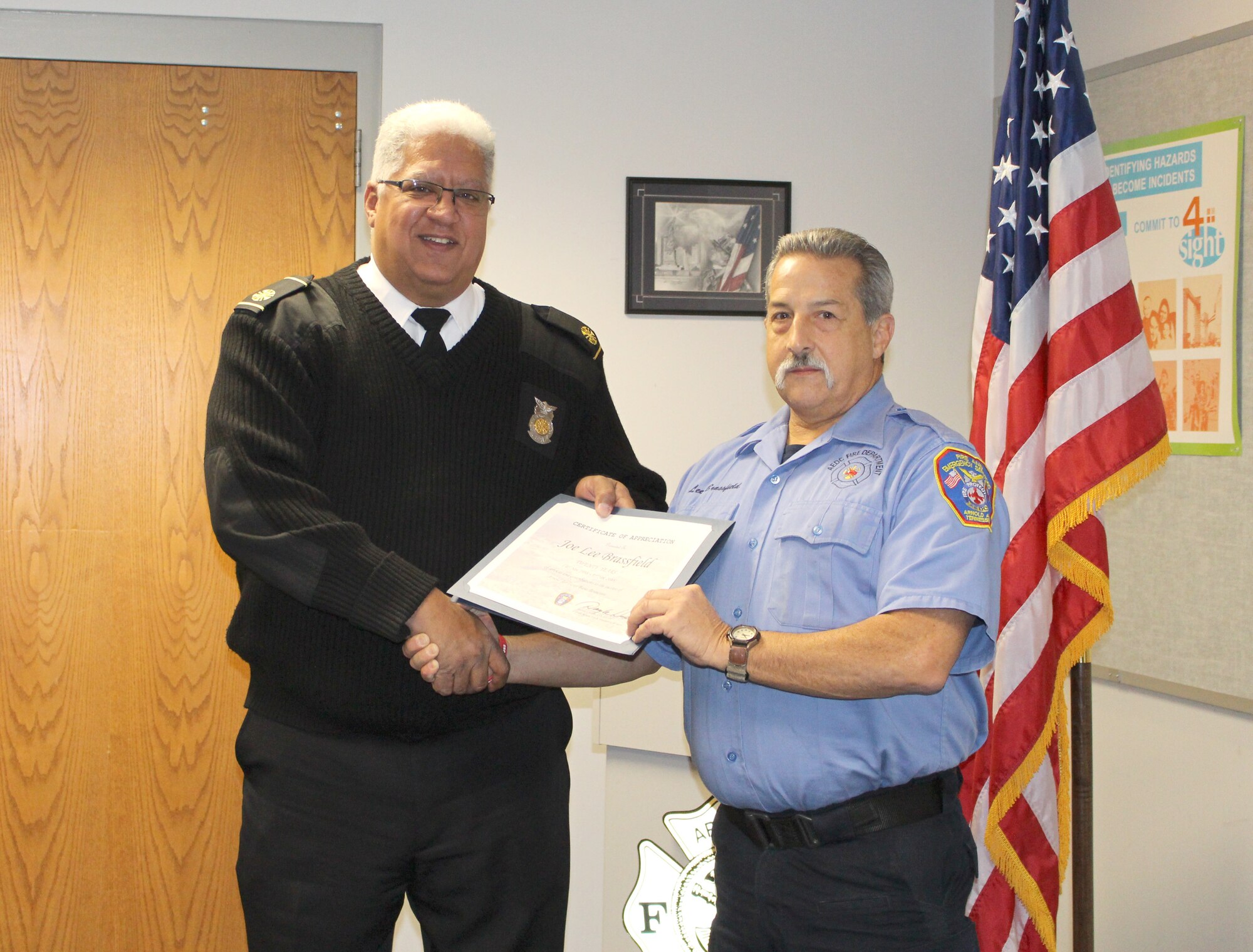 Joe Lee Brassfield, right, driver/operator for Arnold Air Force Base Fire and Emergency Services, receives a certificate recognizing his 20 years of service from Daryle Lopes, chief of Arnold Fire and Emergency Services. (U.S. Air Force photo by Deidre Ortiz)