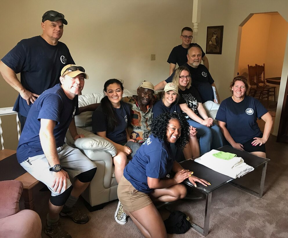 2nd Lt Michelle Burris and several other volunteers posed for a quick picture after setting up the furniture for a veteran who was recently placed into permanent housing.