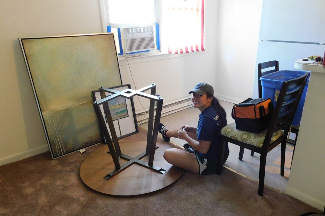 2nd Lt Michelle Burris, assembles a small kitchen table for a veteran during a Vets on Track delivery mission.