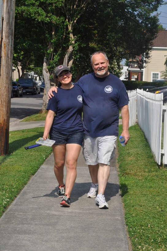 2nd Lt Michelle Burris (left) and Rick Ecker, a retired Marine master sergeant and founder of the Vets on Track Foundation, head back to the trucks after another successful delivery mission supporting veterans