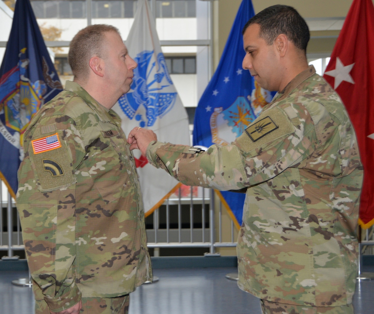 Col. John Andonie, chief of staff for the New York Army National Guard, pins Chief Warrant Officer 3 Albert Thiem, electronic warfare officer for the 42nd Infantry Division,during his promotion ceremony at the Division of Military and Naval Affairs Headquarters in Latham, N.Y., Nov. 9, 2018.