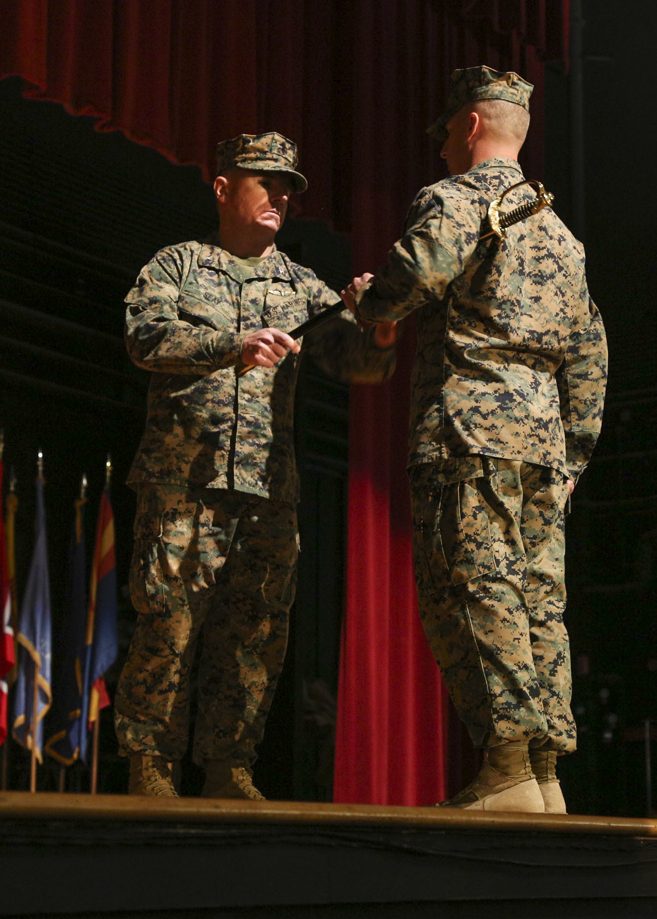U.S. Marine Col. Matthew Seay, commanding officer for Marine Wing Support Group (MWSG) 37, 3rd Marine Aircraft Wing (MAW), hands a non commissioned officer sword to U.S. Marine Sgt. Maj. Paul Agan, sergeant major for MWSG-37, during the group’s reactivation ceremony at Marine Corps Air Station Miramar, Calif. Nov. 29. The passing of the sword is a symbol of the assumption of post as the group sergeant major. (U.S. Marine Corps photograph by Cpl. Joshua S. McAlpine)