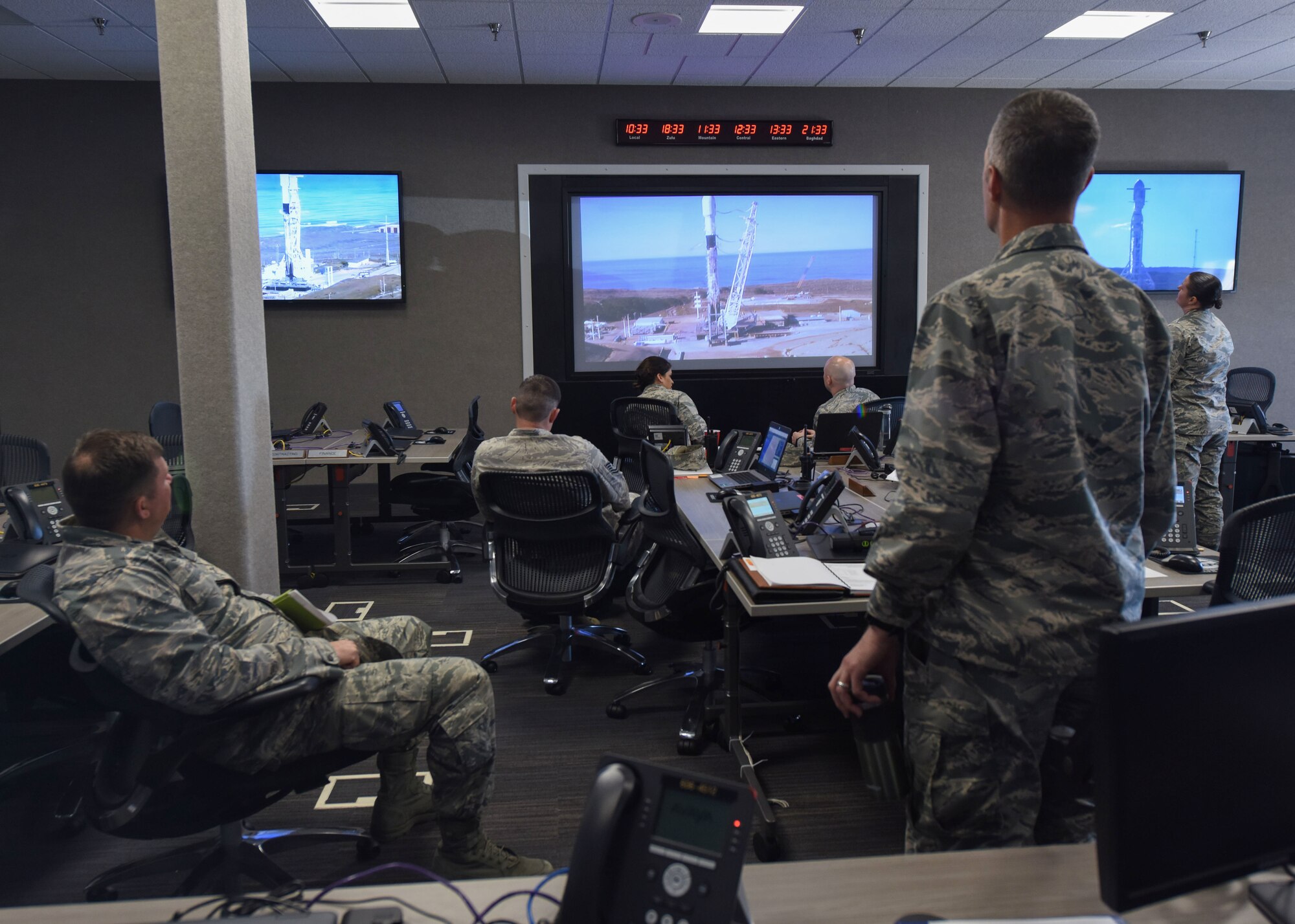 Col. Michael Hunsberger, 30th Mission Support Group commander, and Lt. Col. Jason Aftanas, 30th Civil Engineer Squadron commander, watch the Spaceflight SSO-A: SmallSat Express on a SpaceX Falcon 9 rocket at the Emergency Operation Center, here, Dec. 3, 2018 at 10:34 a.m. “The purpose of the Emergency Operations Center is to support the incident commander, who is typically the head of the Fire Department, with any needs they have if an incident were to occur,” said Hunsberger. (U.S. Air Force photo by Airman 1st Class Aubree Milks/Released)