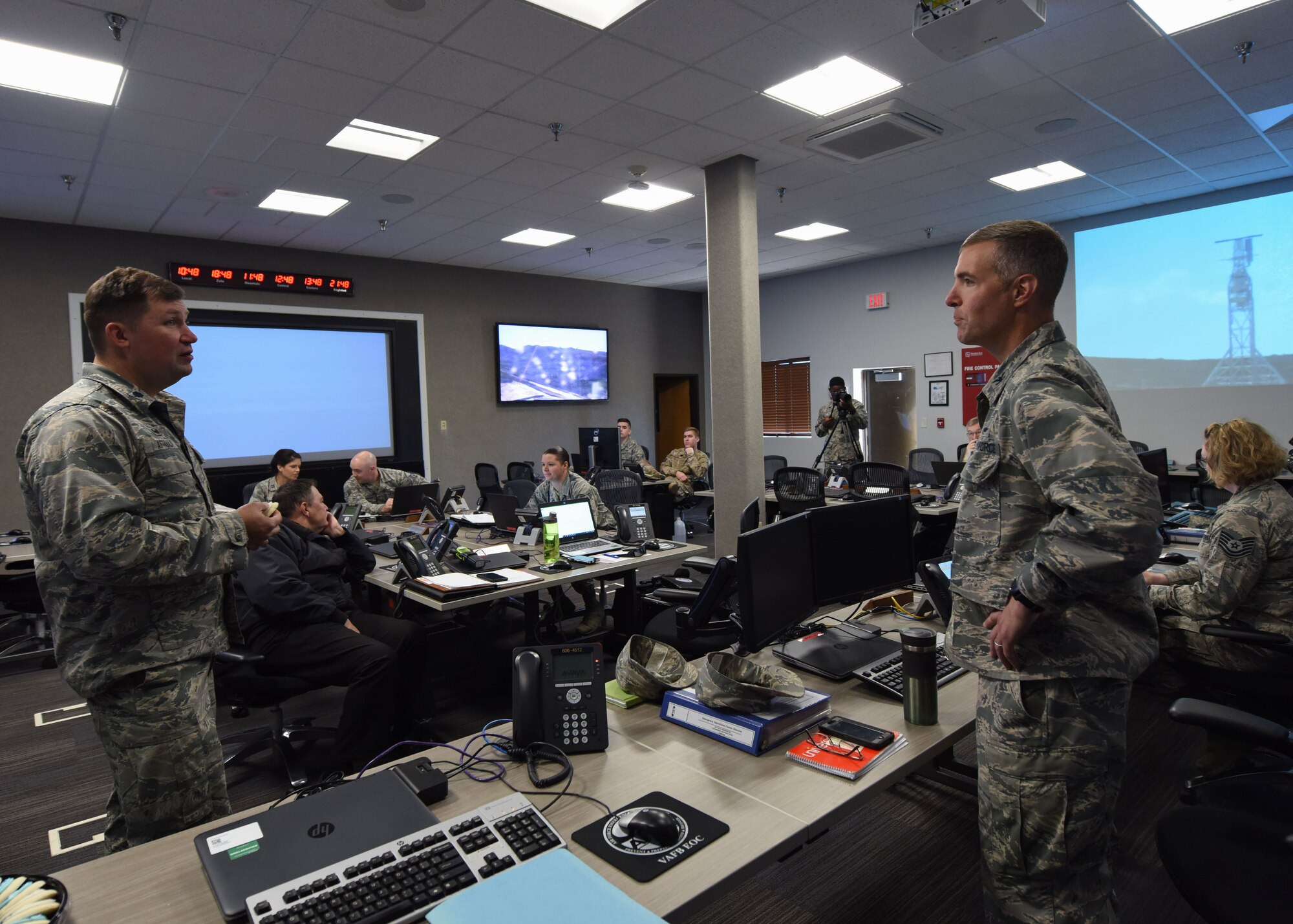Col. Michael Hunsberger, 30th Mission Support Group commander, and Lt. Col. Jason Aftanas, 30th Civil Engineer Squadron commander, discuss the post operations of the Spaceflight SSO-A: SmallSat Express on a SpaceX Falcon 9 rocket at the Emergency Operation Center, here, Dec. 3, 2018 at 10:34 a.m. “The purpose of the Emergency Operations Center is to support the incident commander, who is typically the head of the Fire Department, with any needs they have if an incident were to occur,” said Hunsberger. (U.S. Air Force photo by Airman 1st Class Aubree Milks/Released)