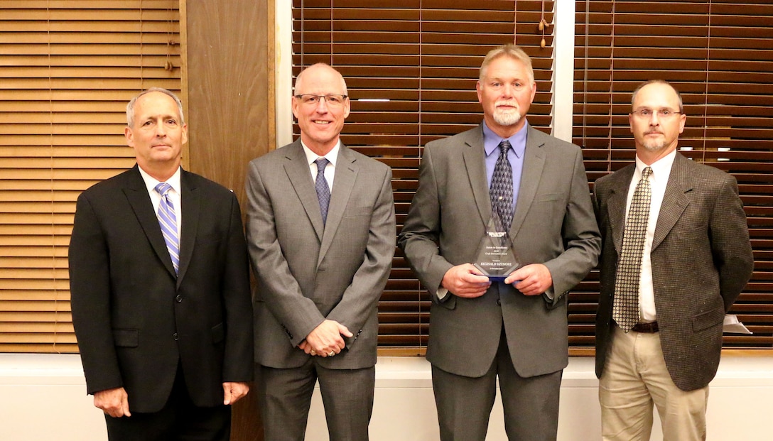 Lead Outside Machinist Reginald Sizemore (third from left) receives the Craft Innovation Award during the National Aerospace Solutions, LLC Salute to Excellence Annual Award Ceremony Nov. 14, 2018, at the Arnold Lakeside Center, Arnold Air Force Base, Tenn. Also pictured from left is NAS Deputy General Manager Michael Belzil, NAS General Manager Richard Tighe and Chugach Base Operations - Utilities Manager Michael Harvey. (U.S. Air Force photo by Bradley Hicks)